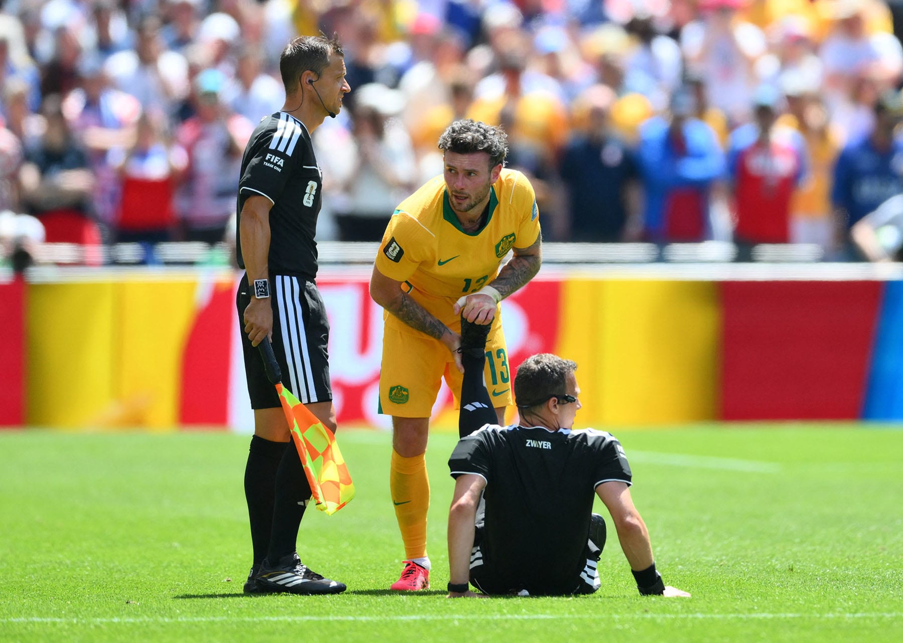 Australia's Aiden O'Neill helps referee Felix Zwayer.