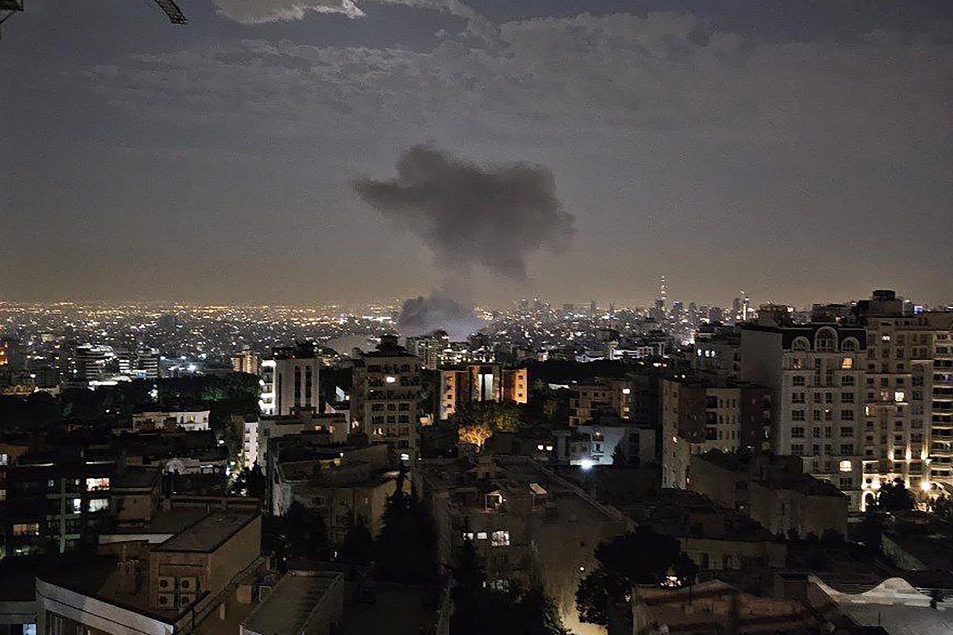 Smoke billows from a site reportedly targeted by an Israeli strike in the Iranian capital Tehran early in the morning of June 13, 2025.