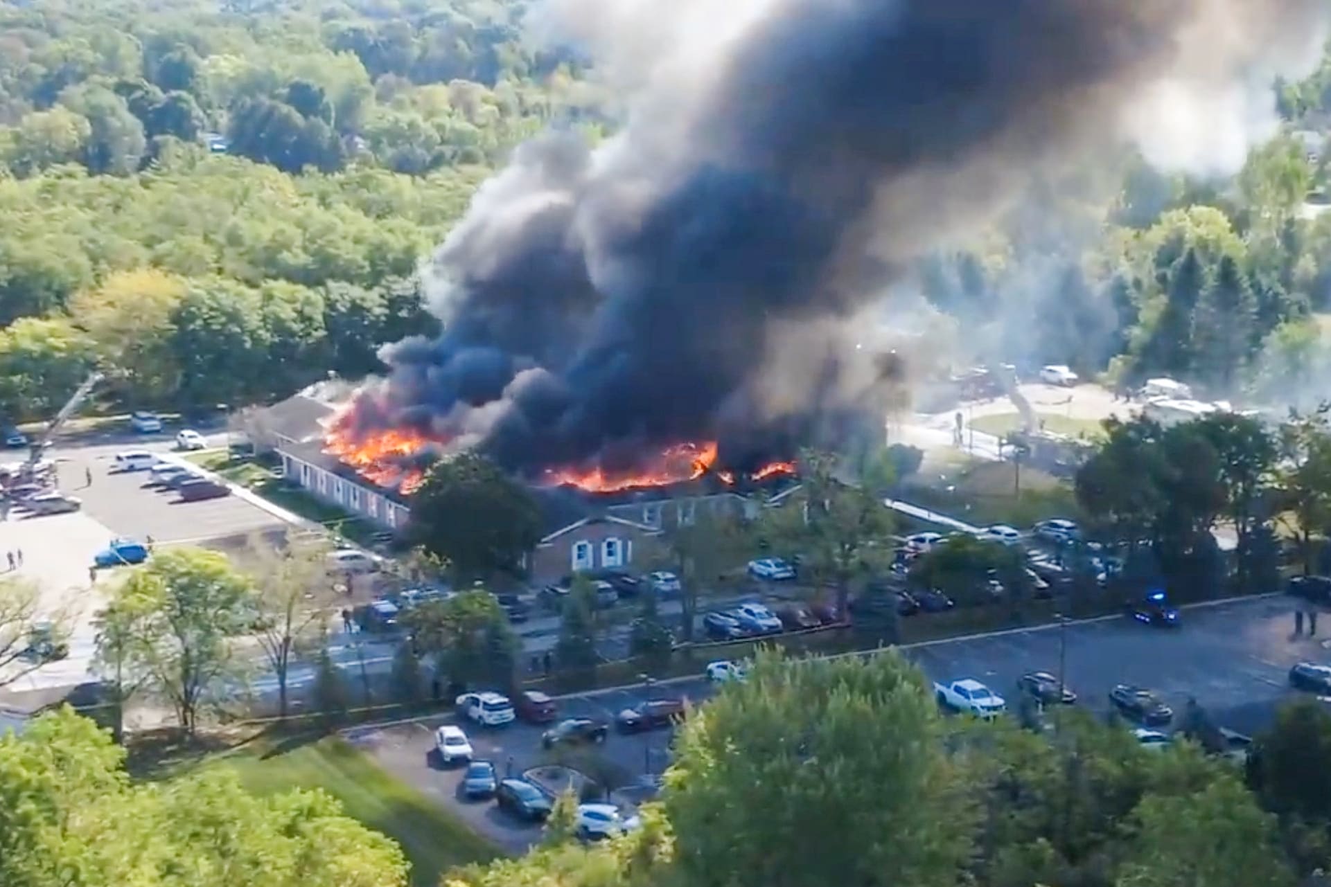 Aerial view of a large plume of smoke engulfing a building