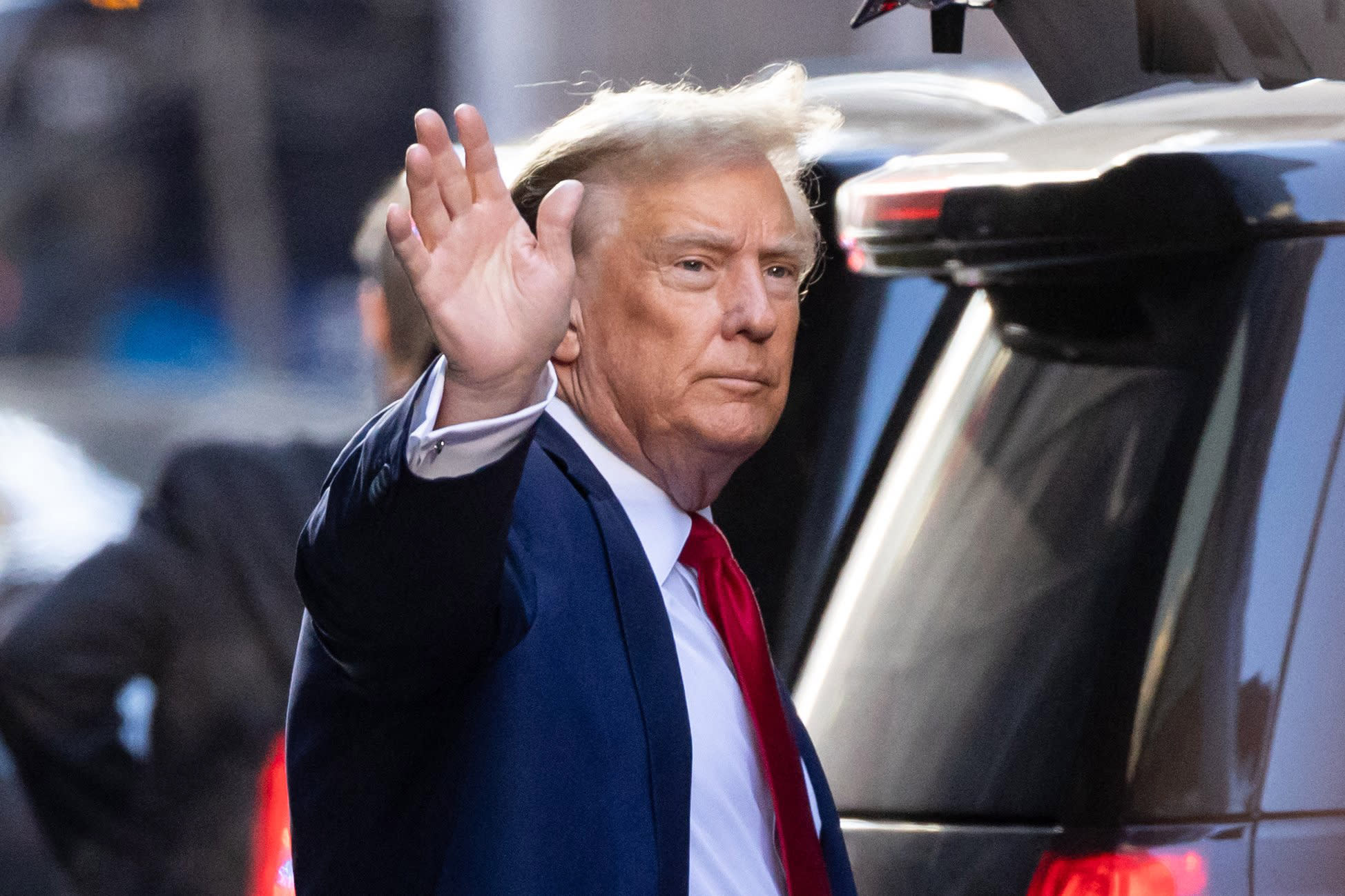 Former President Donald Trump waves as he departs Trump Tower on his way to New York Supreme Court in New York City on Feb. 15, 2024.