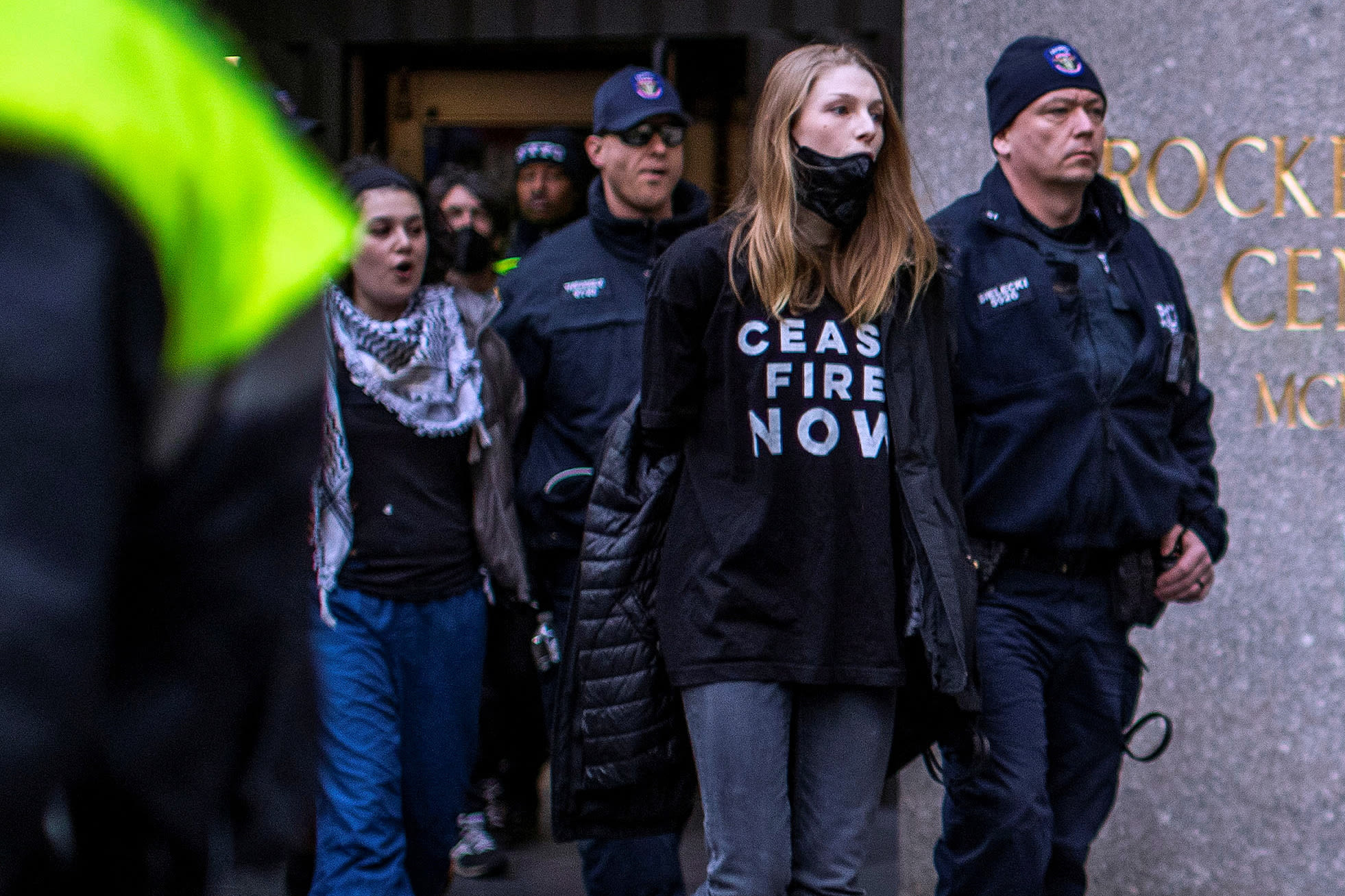 New York police officers detain Hunter Schafer, center, at Rockefeller Center in New York City