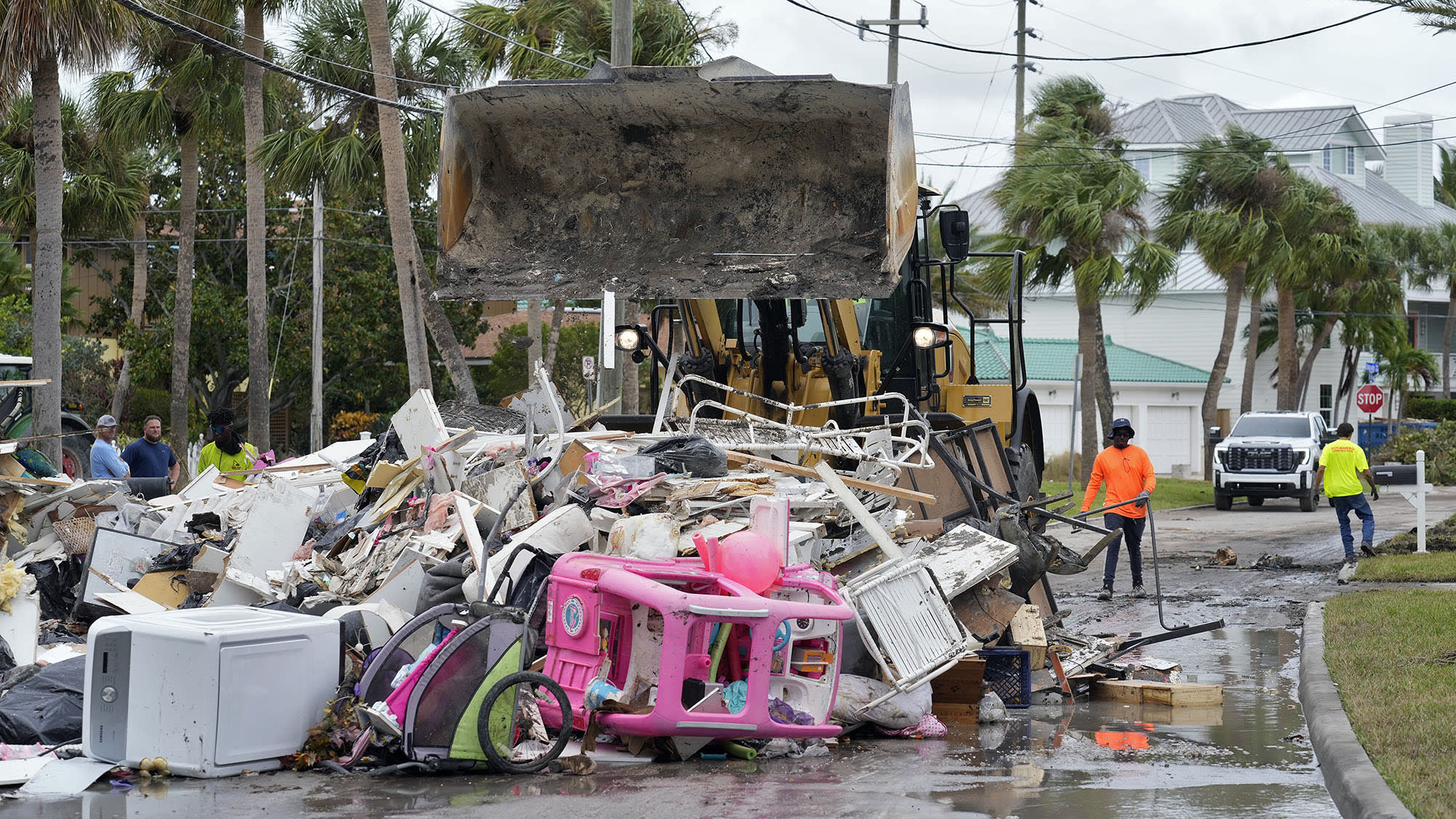 Salvage workers remove debris from Hurricane Helene on Monday, Oct. 7, 2024, in Clearwater Beach, Fla.