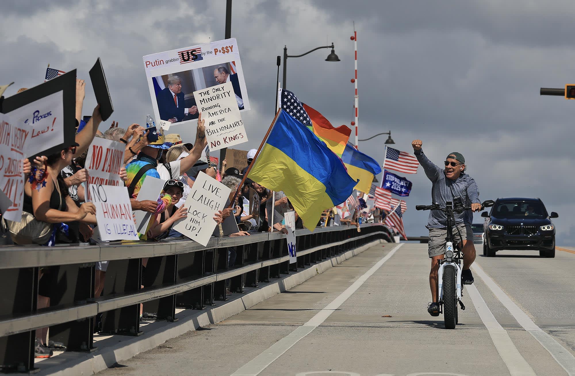 Protesters march near President Donald Trump's Mar-a-Lago home during a "No Kings Day" protest on June 14, 2025 in West Palm Beach, Fla.