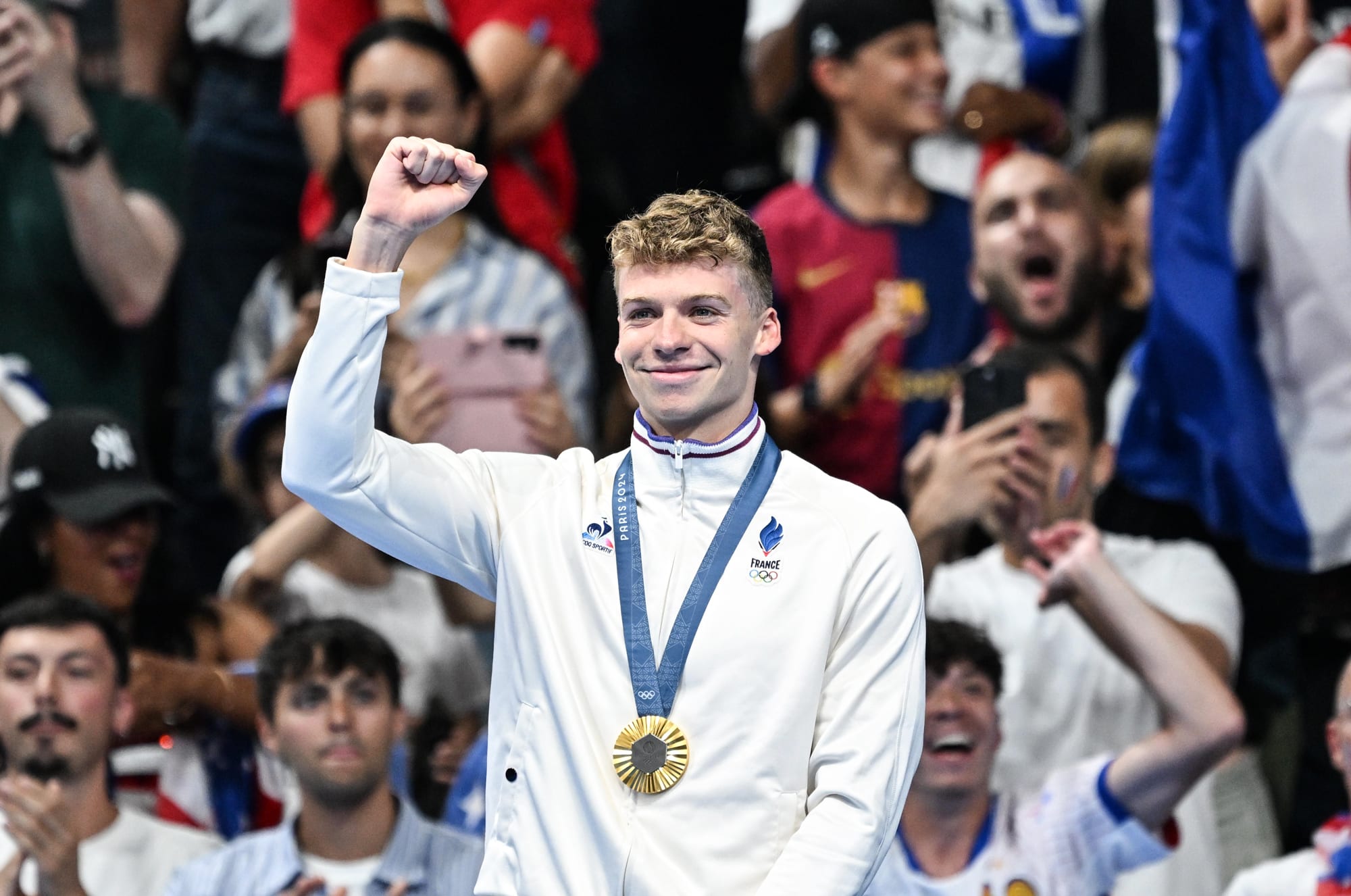 Leon Marchand raises a fist