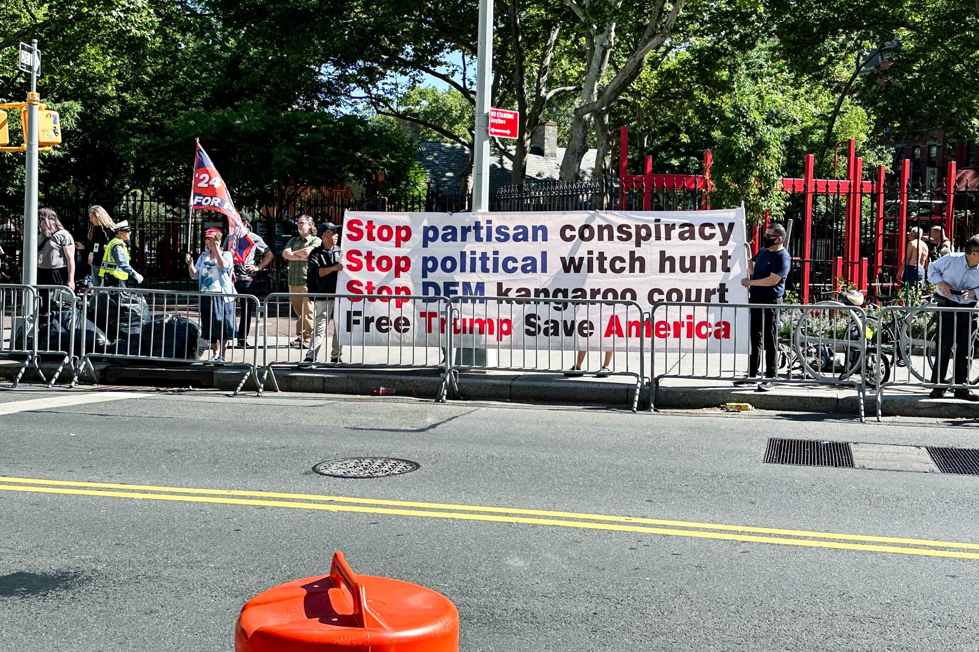 A small group of Trump supporters at the corner of Baxter and Worth