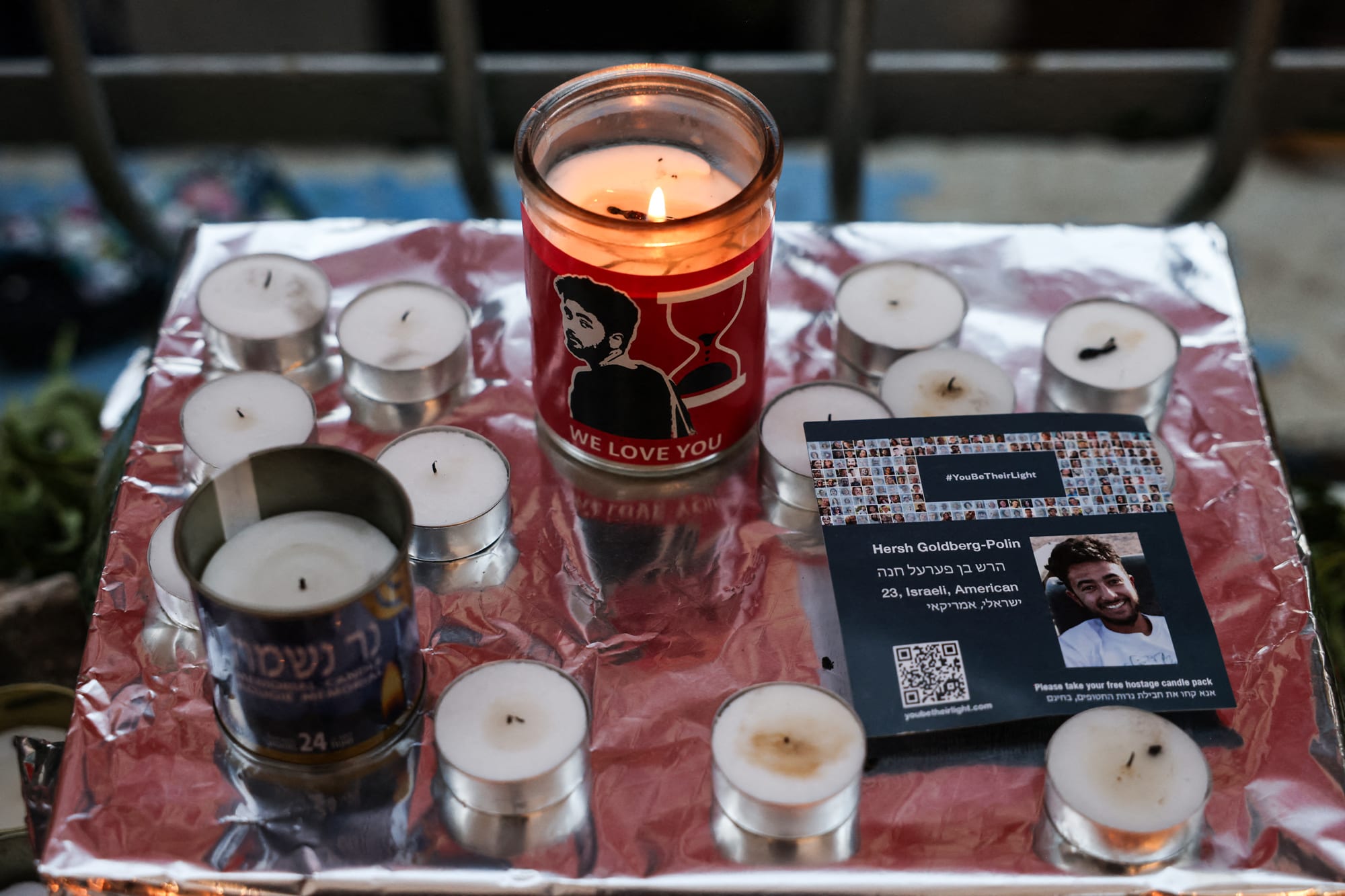 Pictures of killed Israeli hostage Hersh Goldberg-Polin are placed among candles on a table