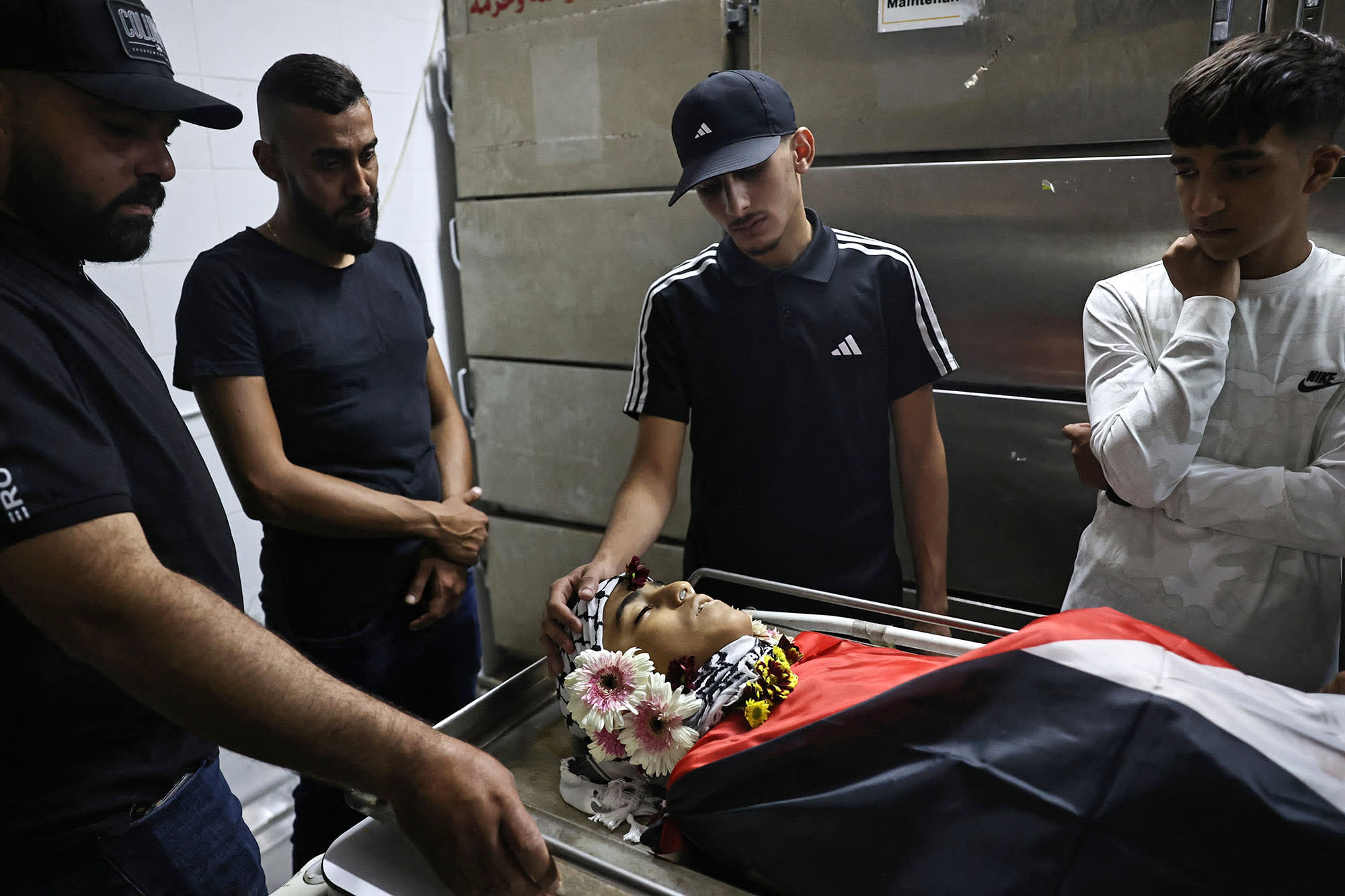 Relatives mourn over the body of 12-year-old Palestinian Hatem Sami Ghaith, who died as a result of wounds sustained during an Israeli raid, in Ramallah in the West Bank on Oct. 7, 2024.