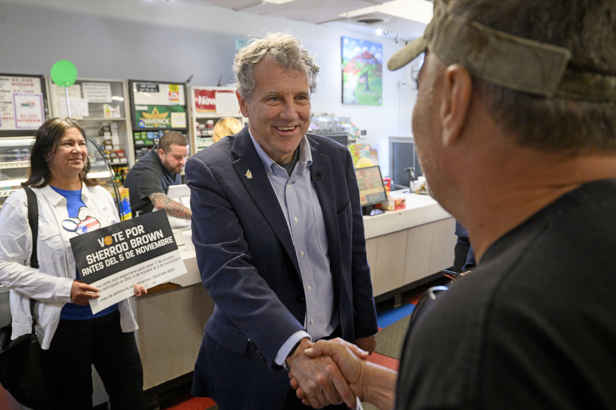 Sen. Sherrod Brown, D-Ohio, talks with voters at a Puerto Rican owned and operated grocery