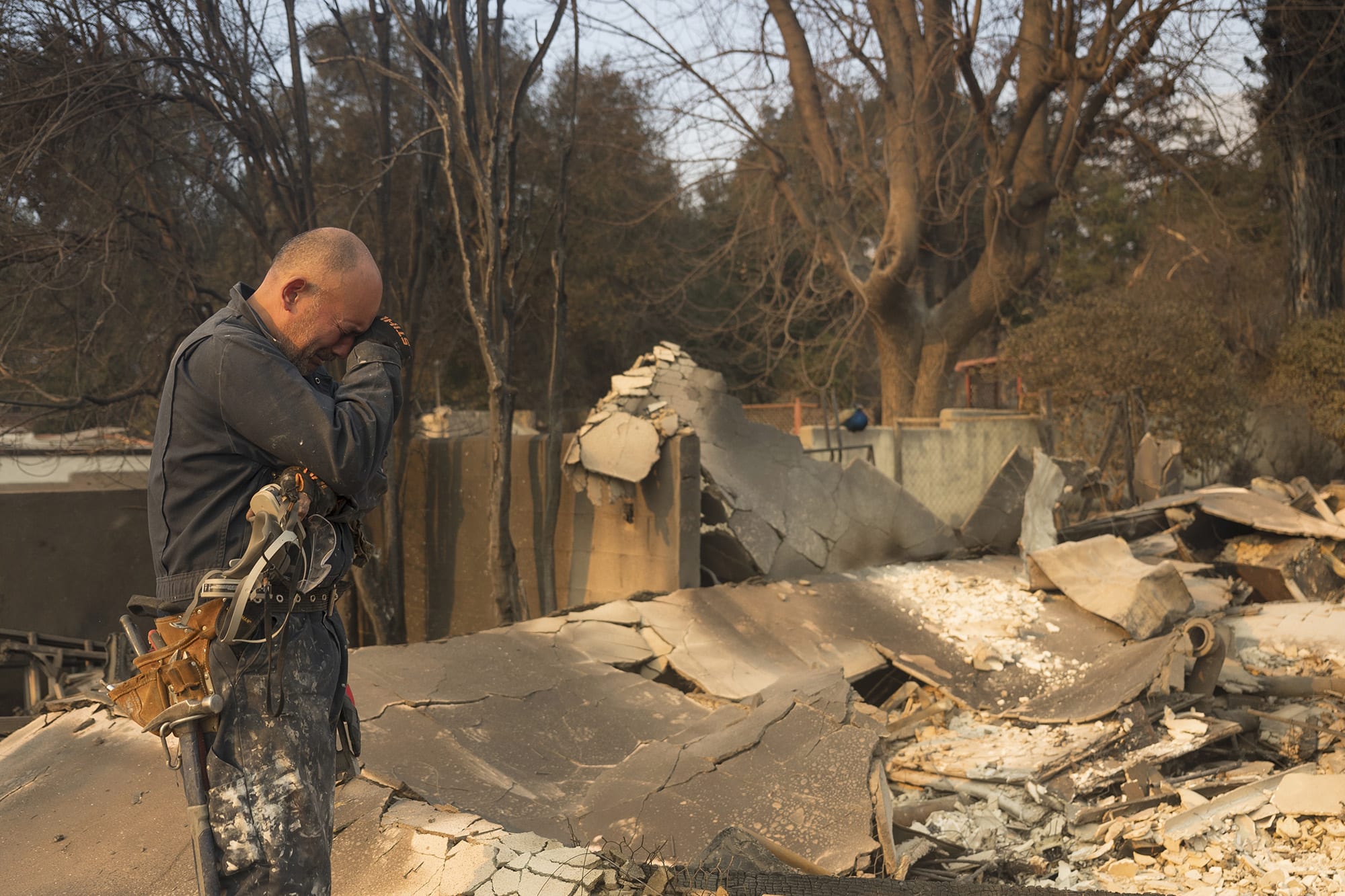Cesar Plaza becomes emotional while looking at his home destroyed by the Eaton Fire in Altadena, Calif., Thursday, Jan. 9, 2025. 
