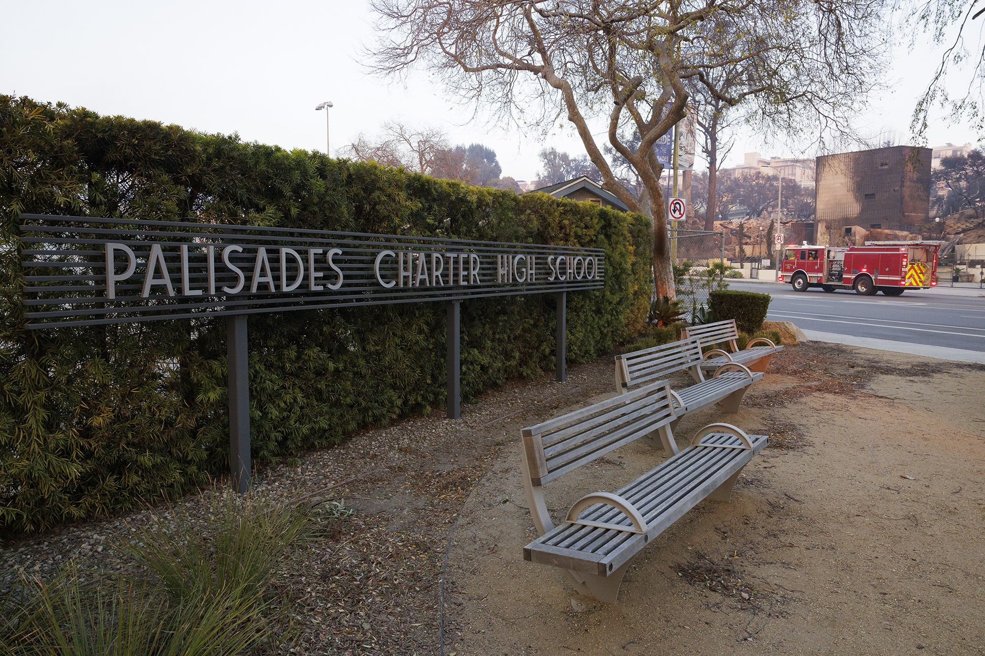 A firetruck drives past the Palisades Charter High School.