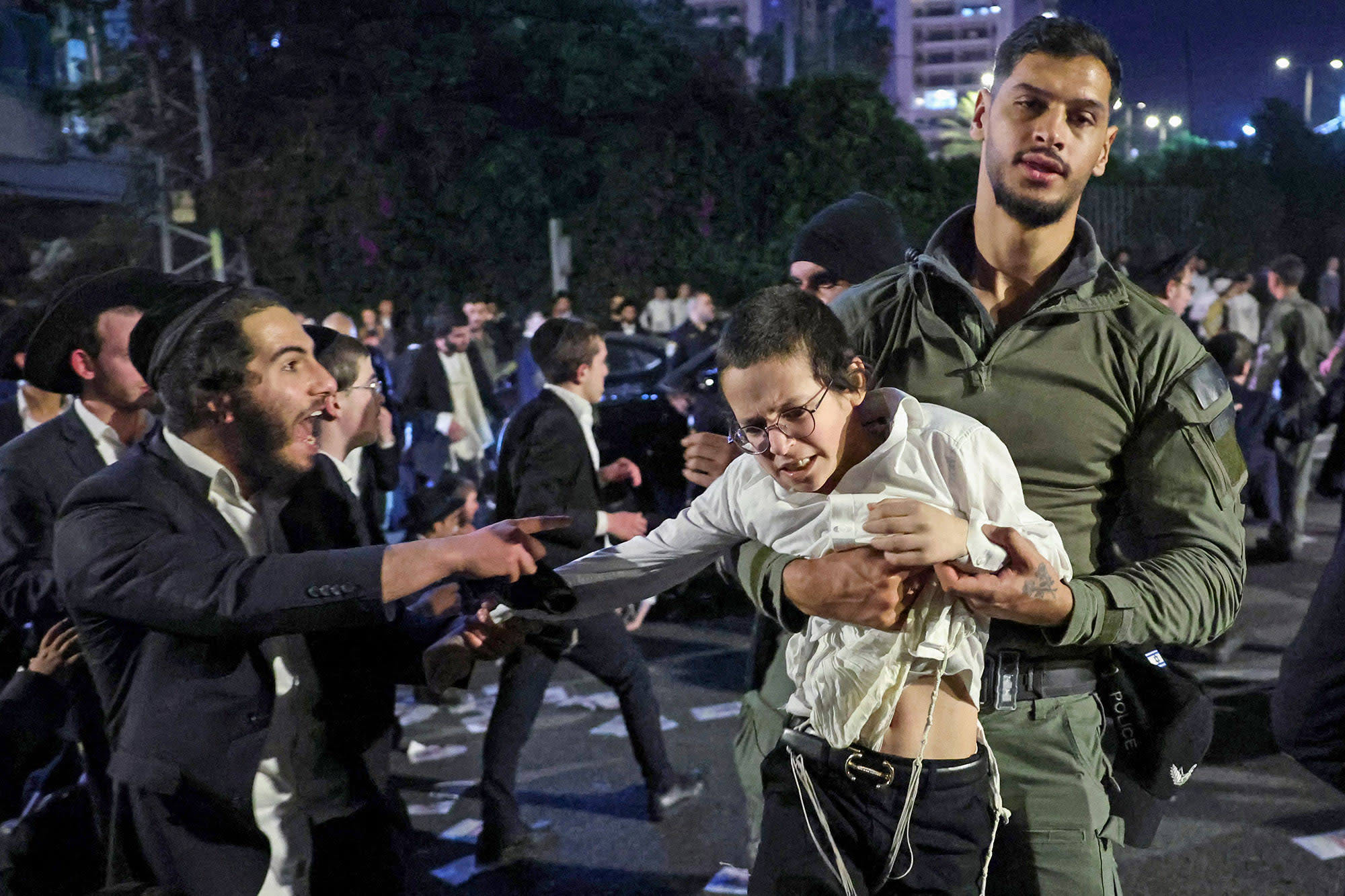 Members of Israeli security forces remove ultra-Orthodox Jewish demonstrators 