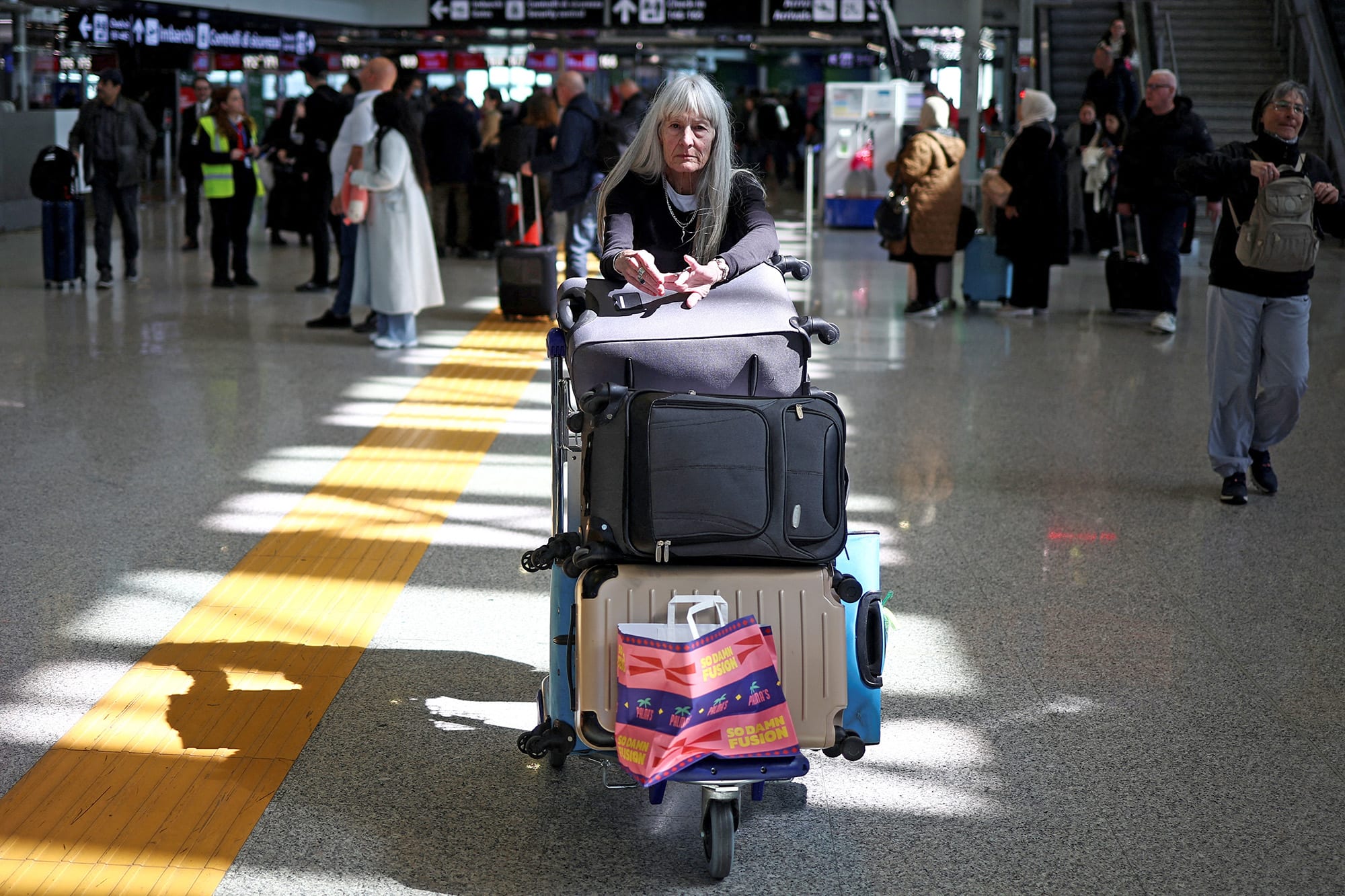 American Joanne Davis, who was hoping to fly to Portland, Ore., via Heathrow, waits in Fiumicino Airport near Rome on March 21, 2025. 