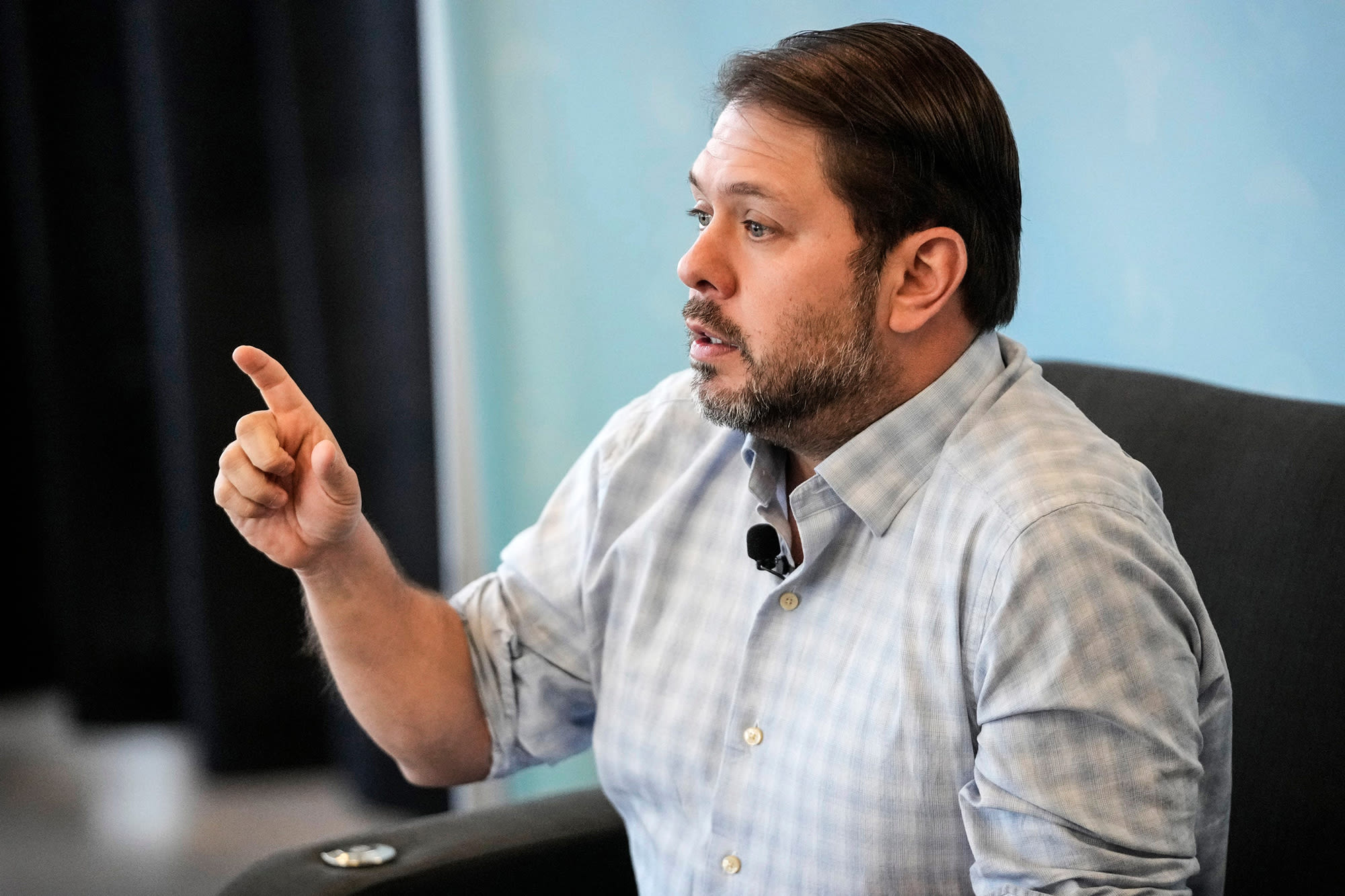 Ruben Gallego speaks while seated and pointing
