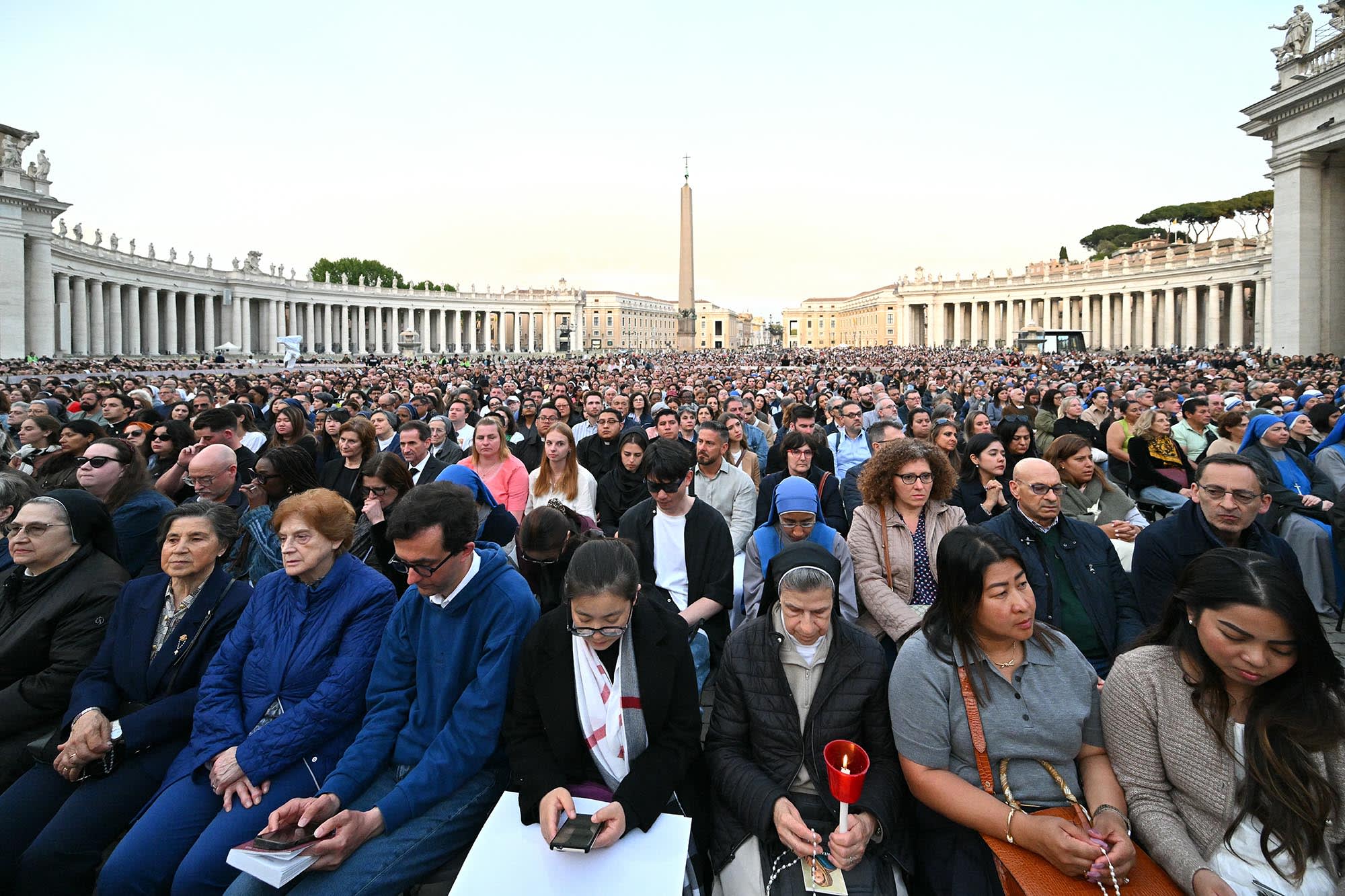 Devotees attend a Rosary in homage to Pope Francis in Saint Peter's Square, the Vatican, on April 21, 2025.