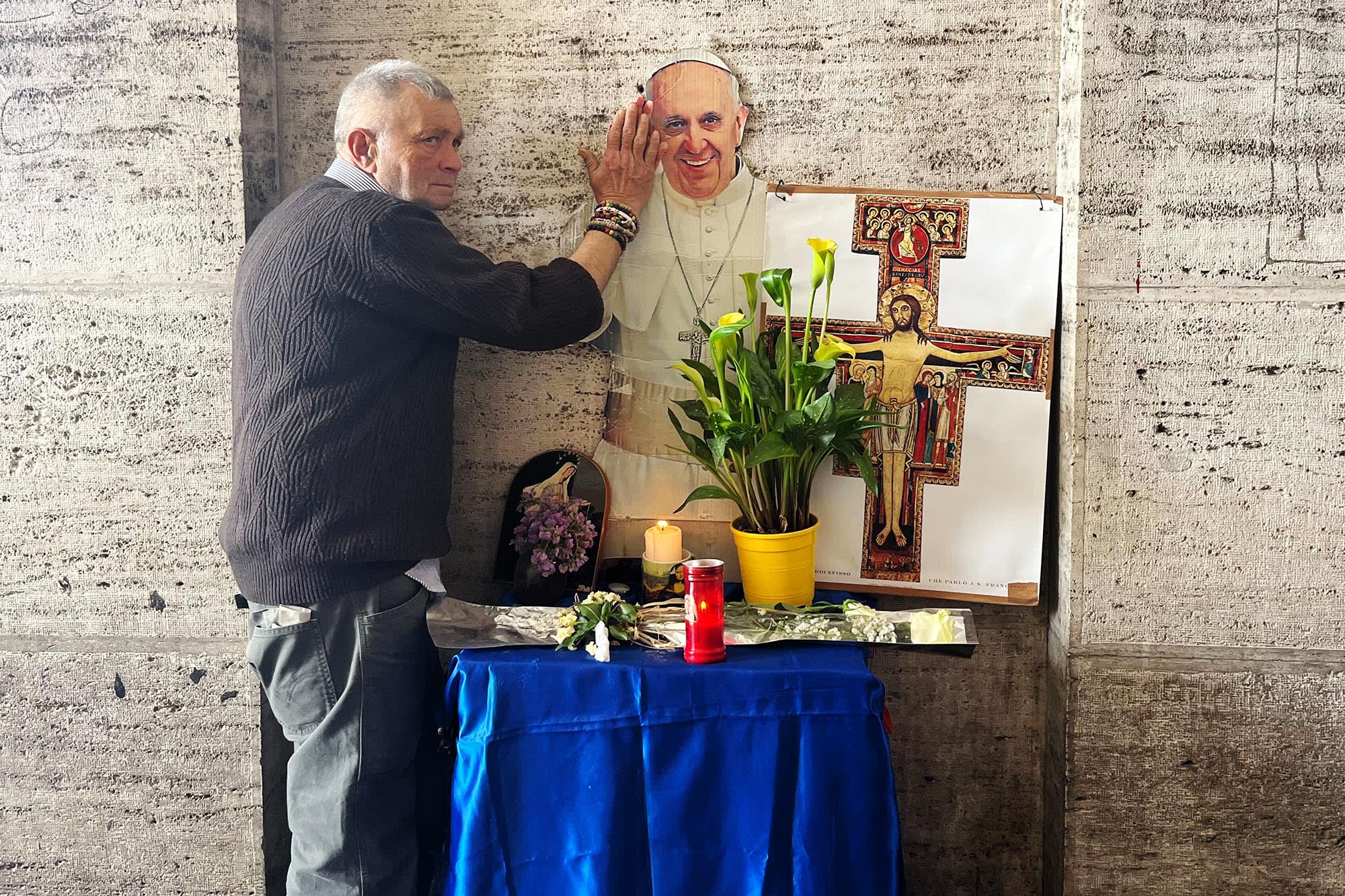 Ulcer Vasile Paul poses in front of a small shrine he created for Pope Francis in Rome.
