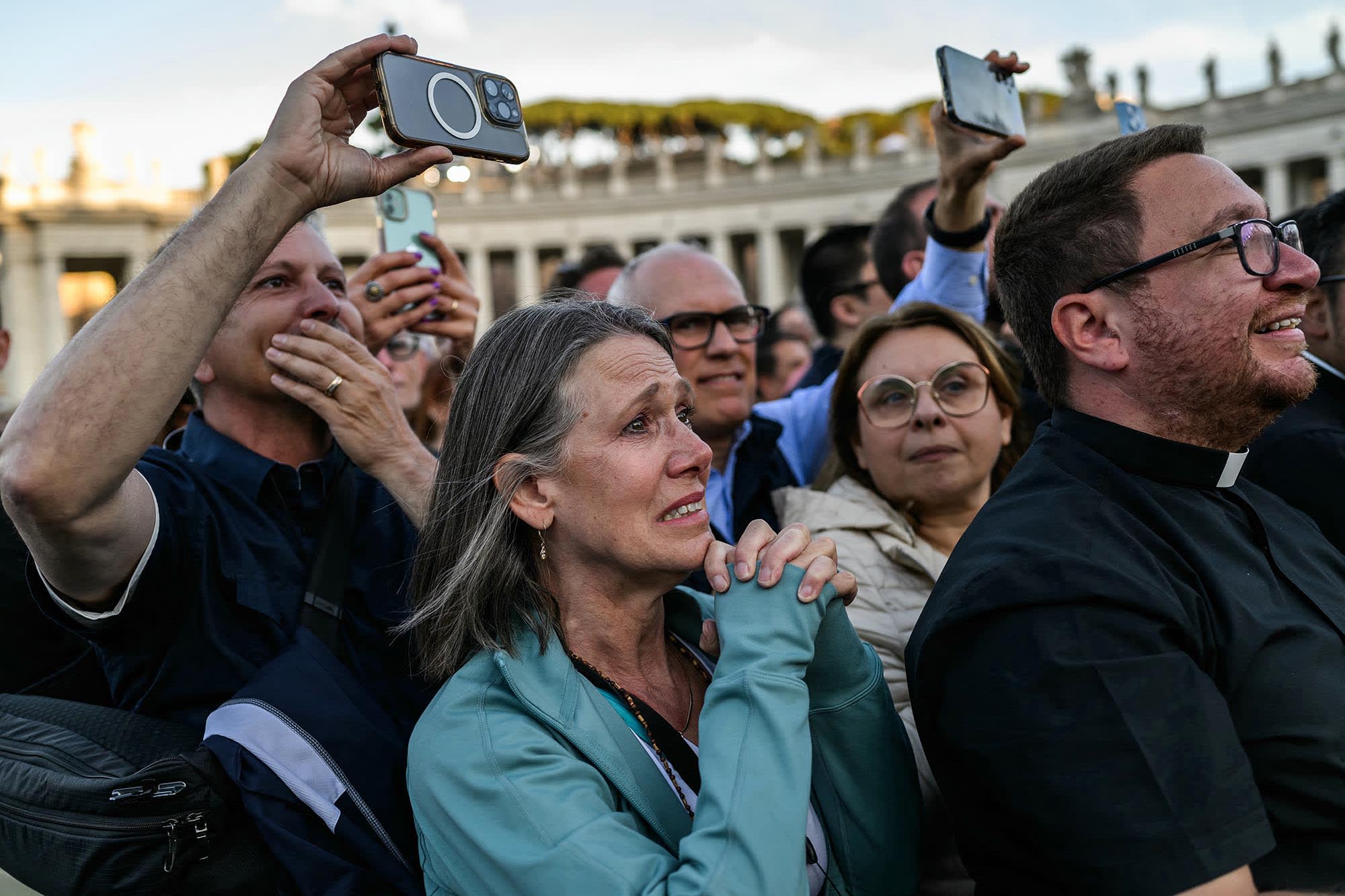 A woman reacts as the newly elected Pope Leo XIV, Robert Prevost maks his first appearance in the main central loggia balcony of the St Peter's Basilica on May 8, 2025.