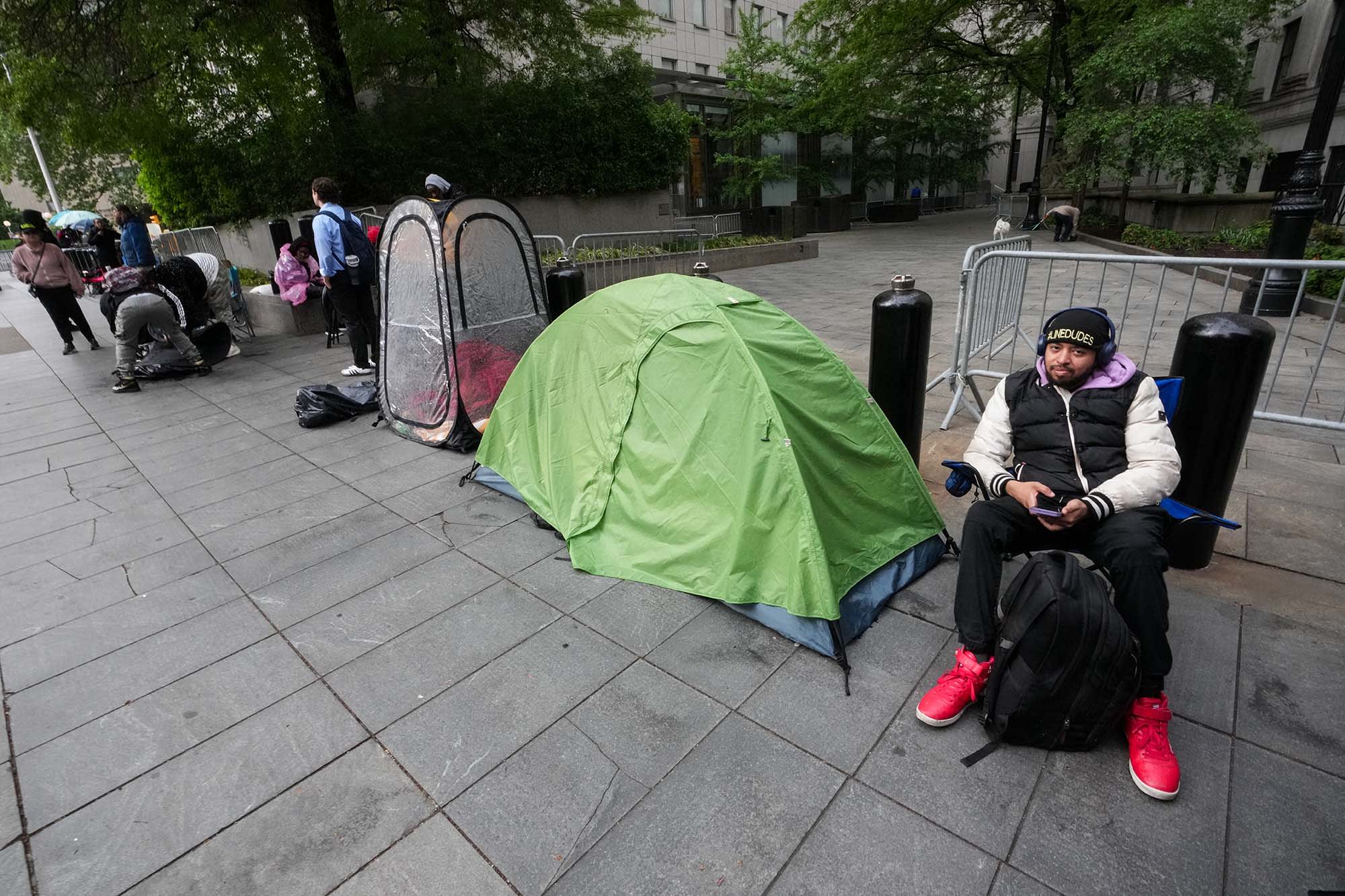 People wait in line to enter federal court for Sean "Diddy" Combs' sex trafficking trial in New York City on May 14, 2025.