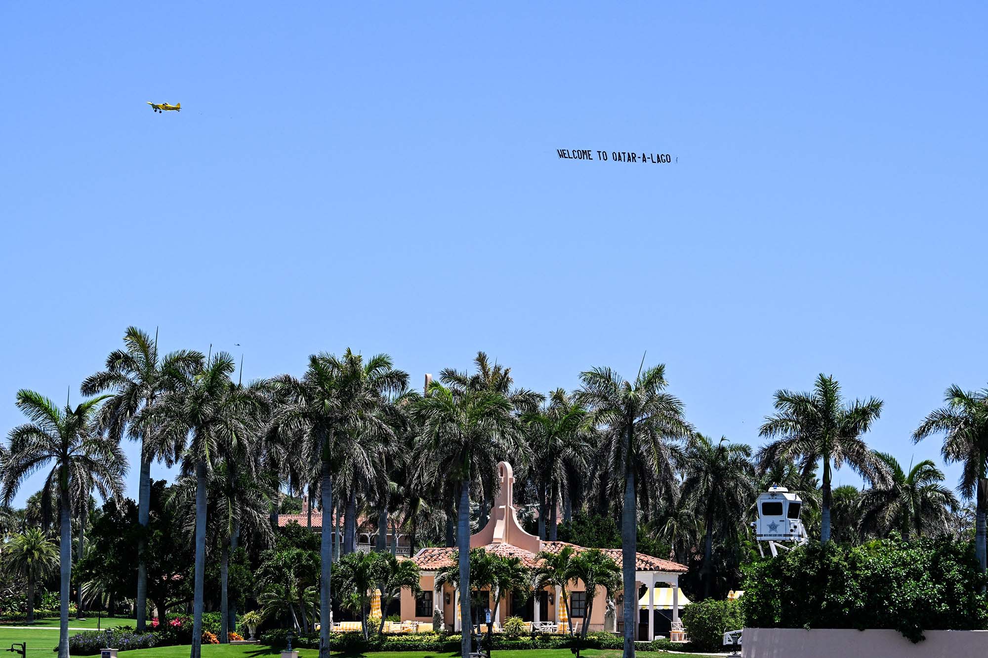 A banner with the words "Qatar-a-Lago" flies in the sky near President Donald Trump's Mar-a-Lago residence