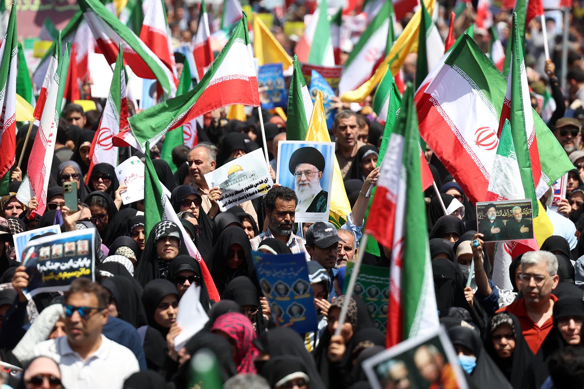 Iranians wave their national flag and wave placards during an anti-Israeli rally in Tehran on June 20, 2025.