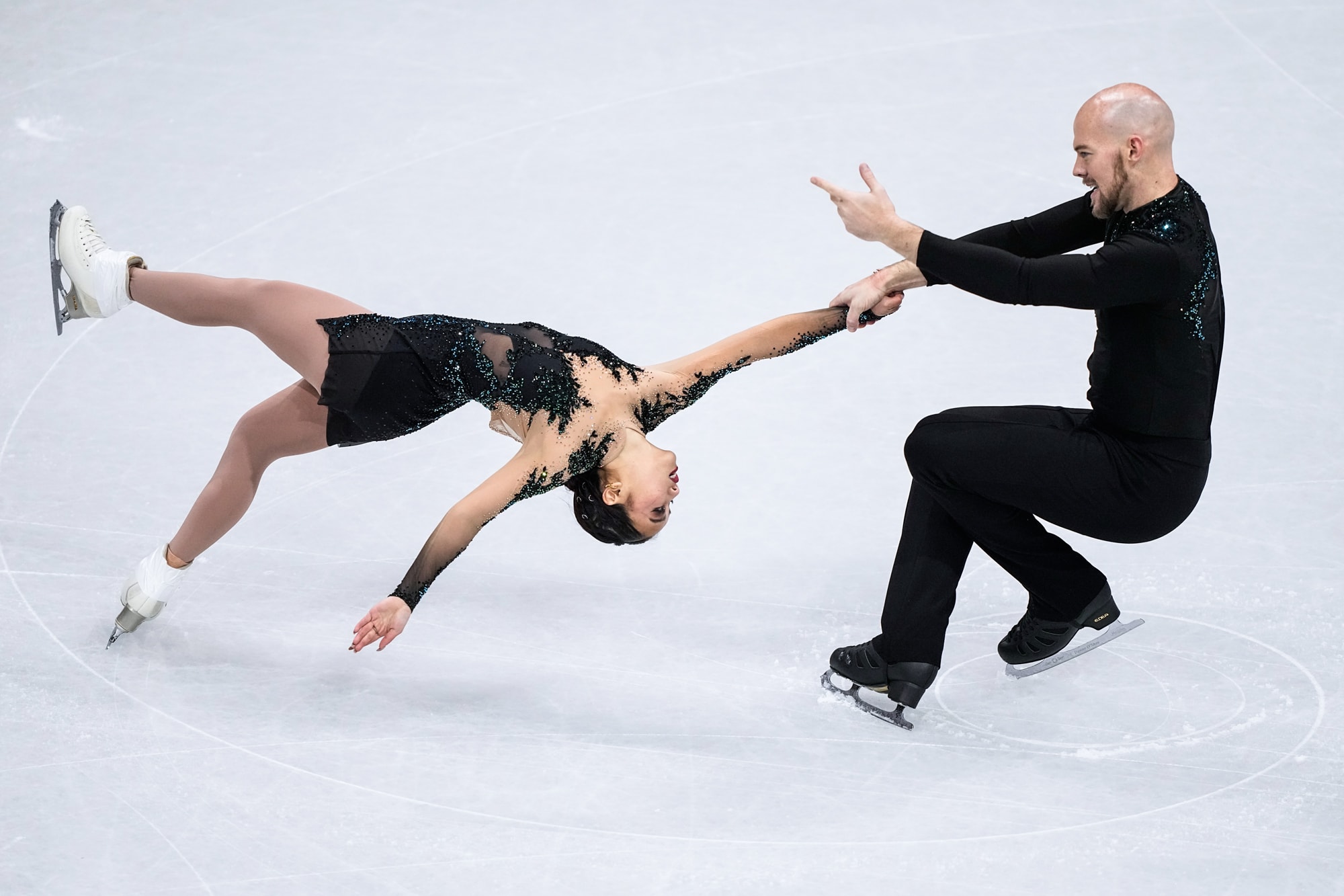 Ellie Kam and Danny O'Shea skate on the ice
