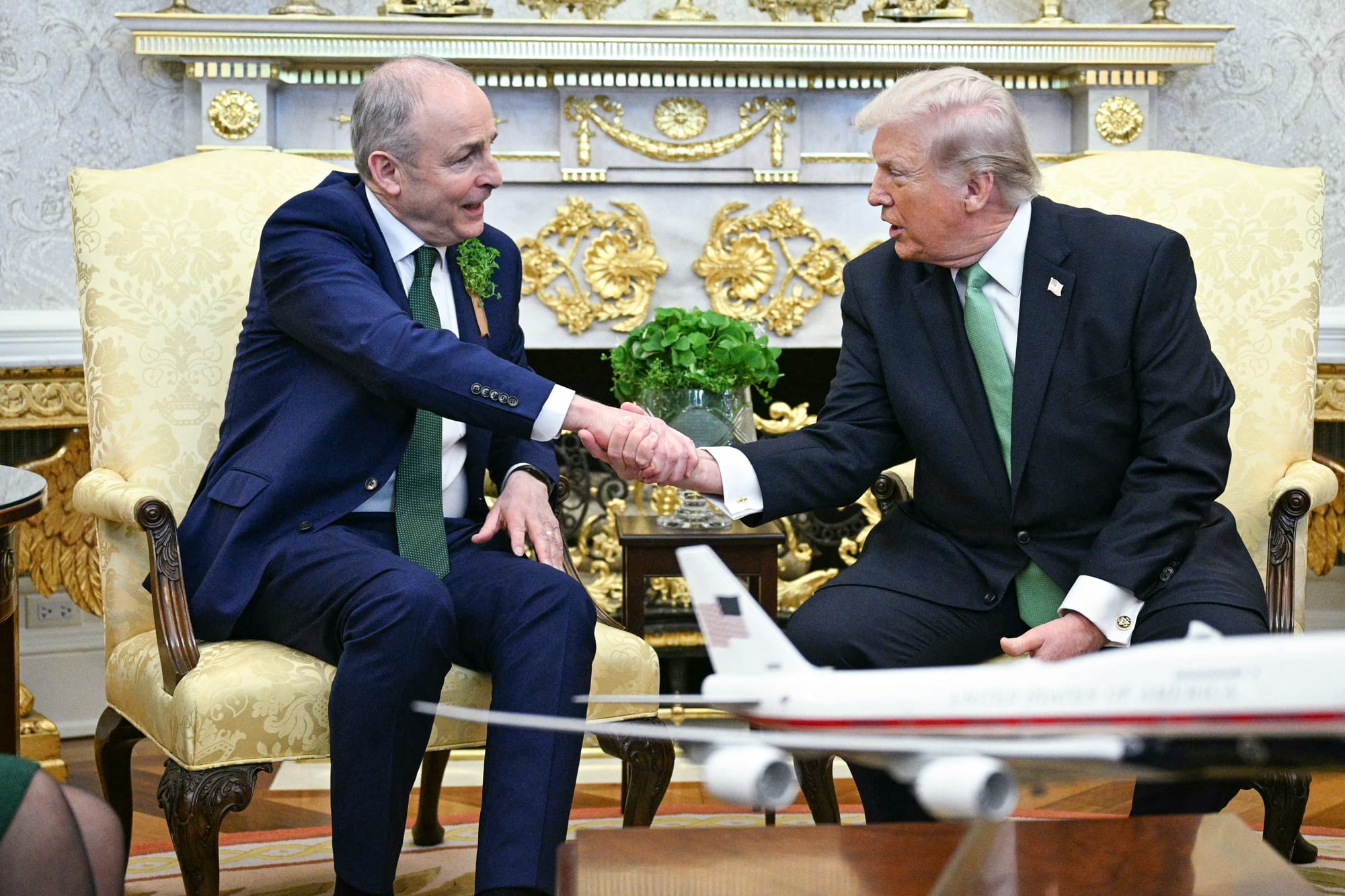 Micheal Martin, left, and Donald Trump shake hands while seated in the Oval Office of the White House