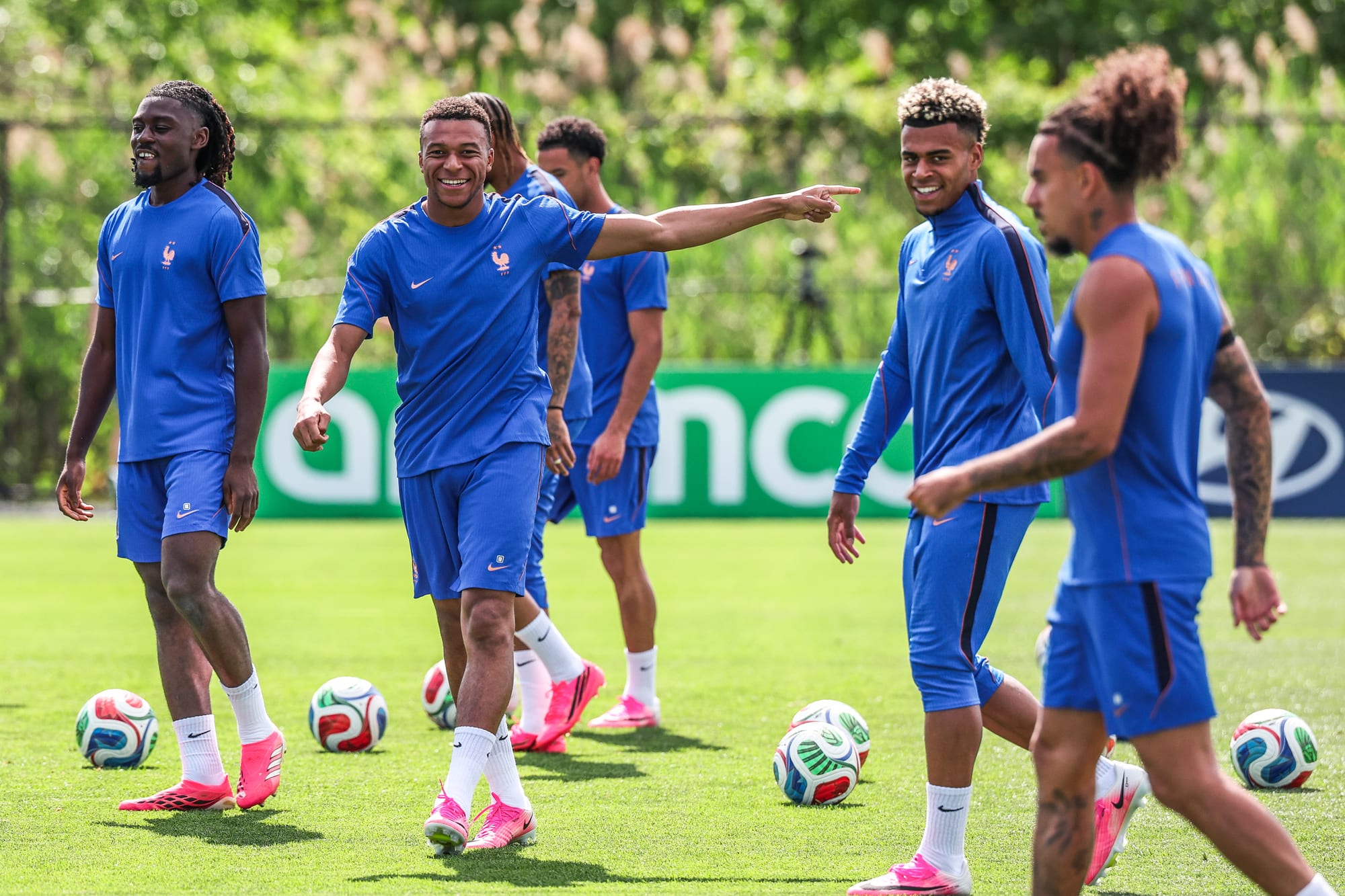 Team France players practice on the soccer field, Mbappe is center