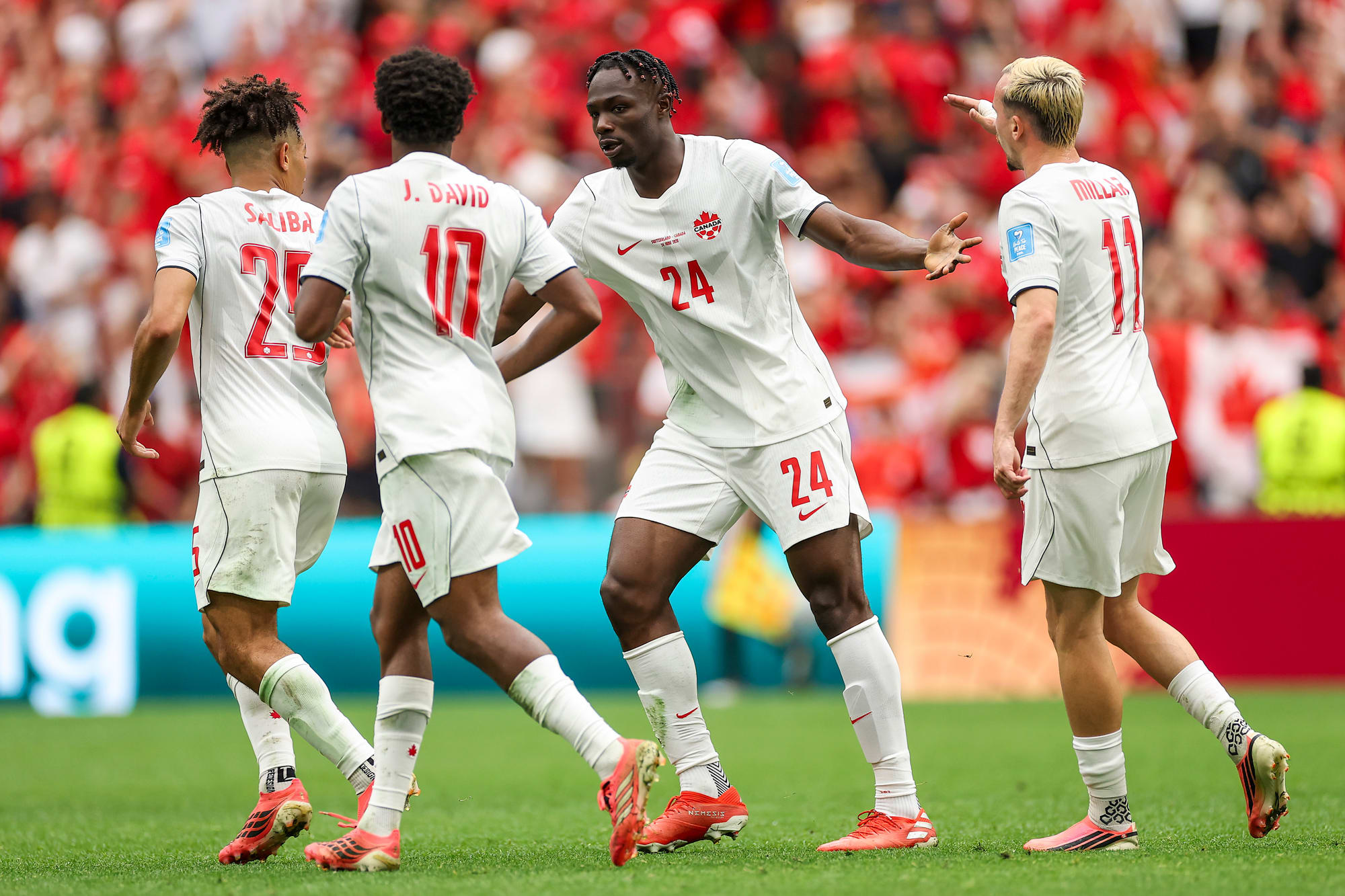 Promise David celebrates with teammates on the field