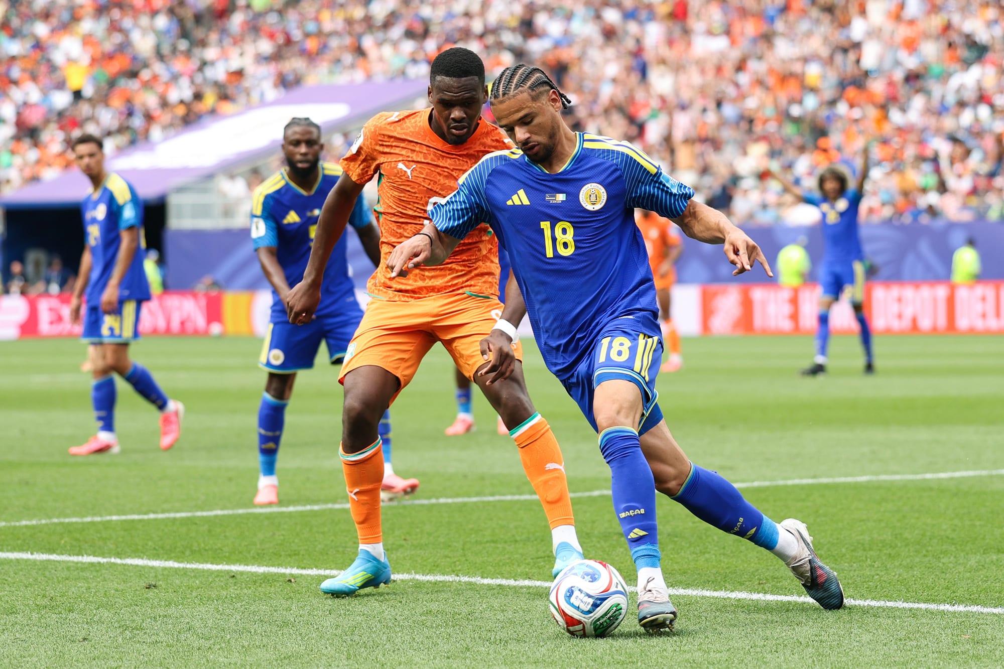 Armando Obispo #18 of Curacao controls the ball against Juergen Locadia #9 of Curacao on the soccer field