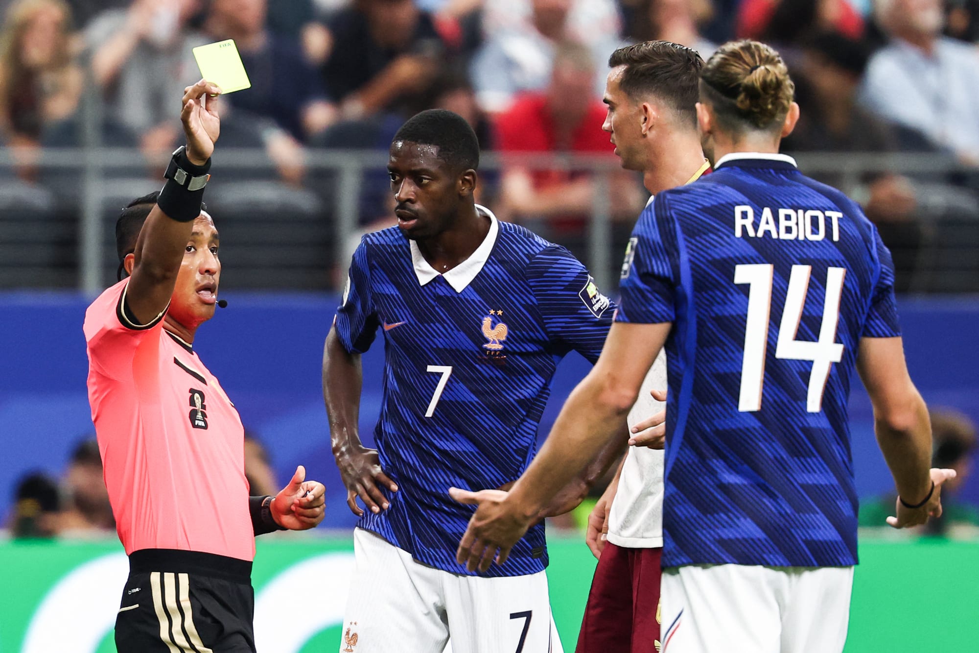 Ivan Barton shows a yellow card to Adrien Rabiot on the soccer field