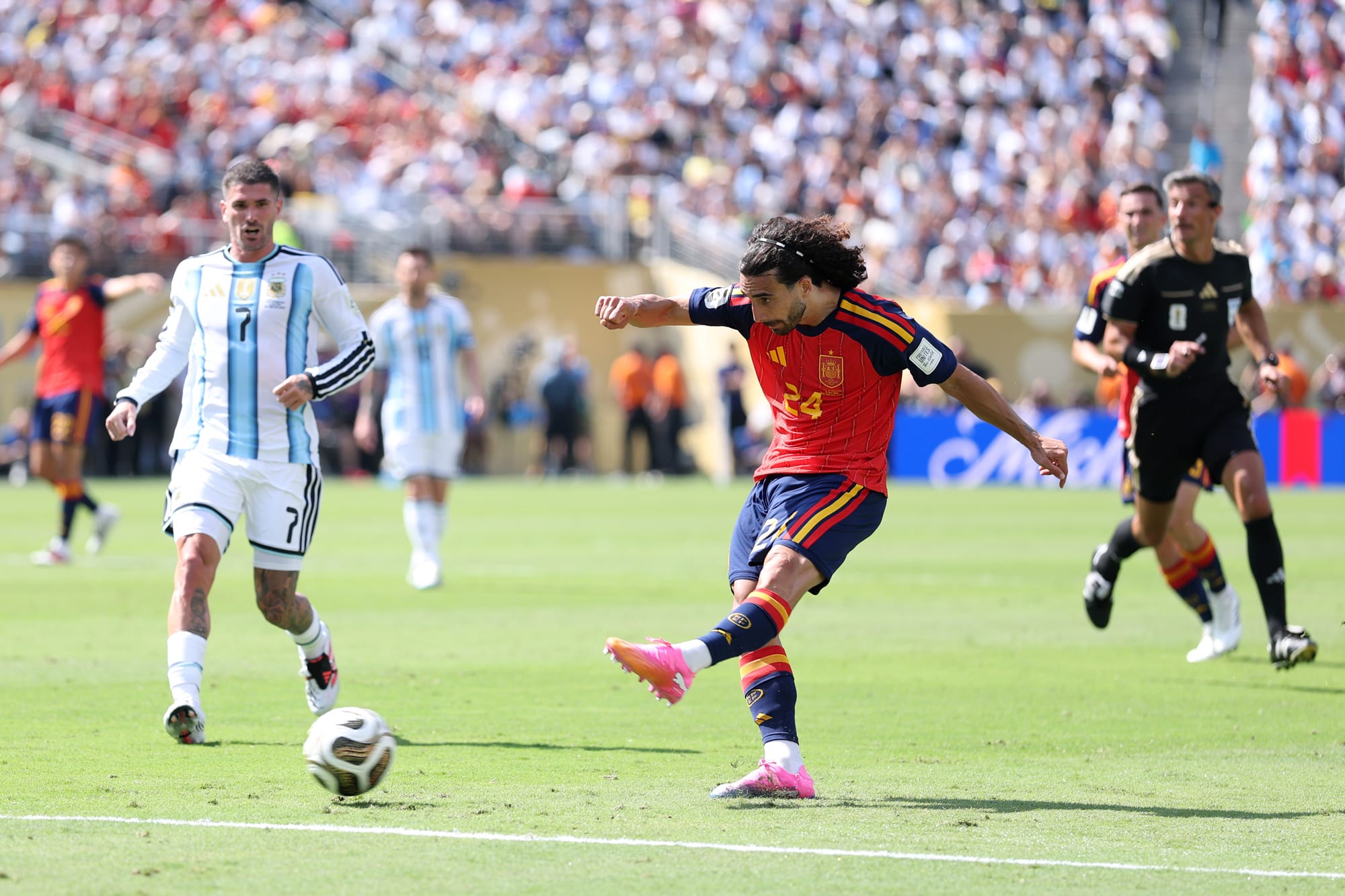 Marc Cucurella kicks the soccer ball on the field