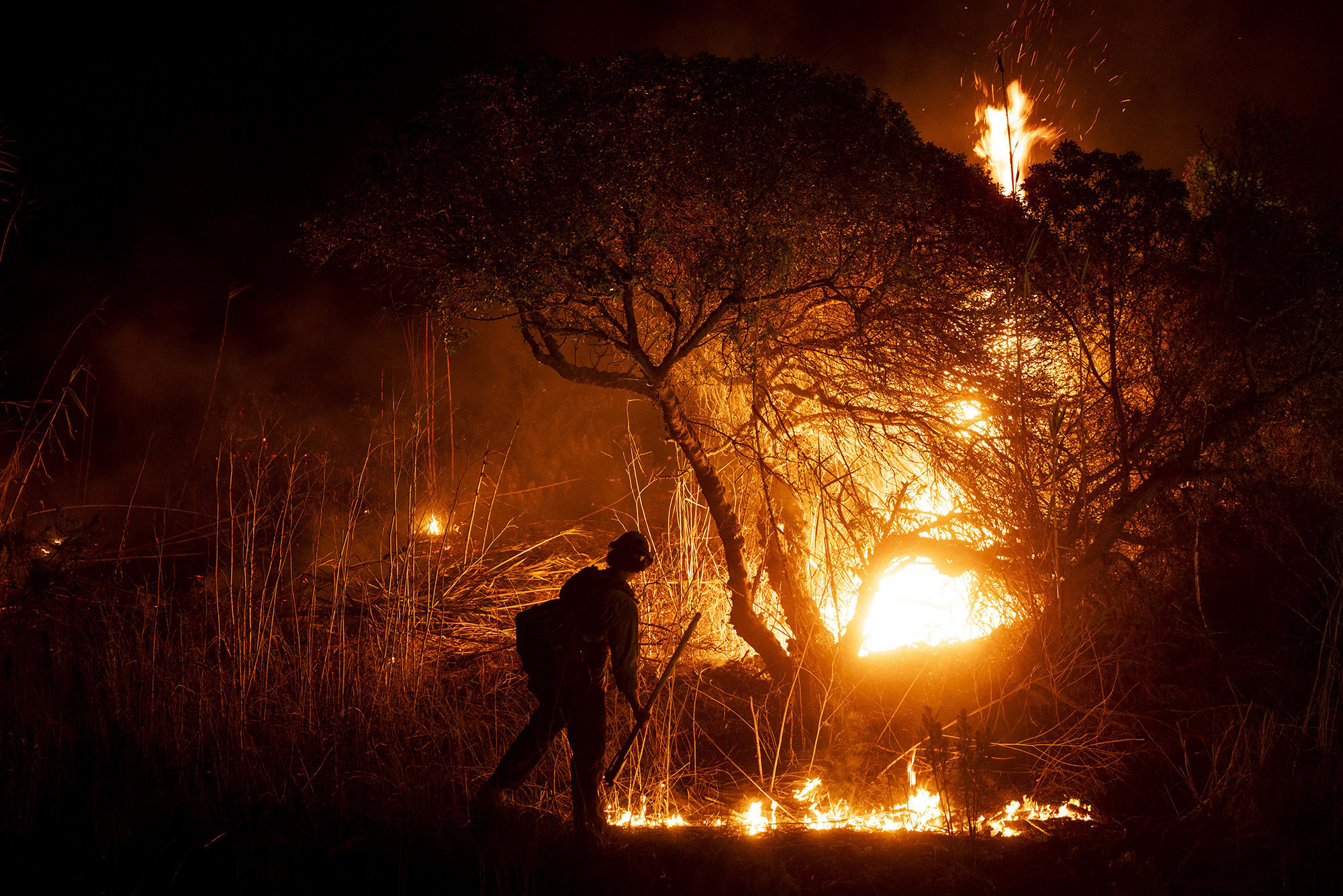 A firefighter monitors the spread of the Auto Fire in Oxnard, Calif., on January 13, 2025. 