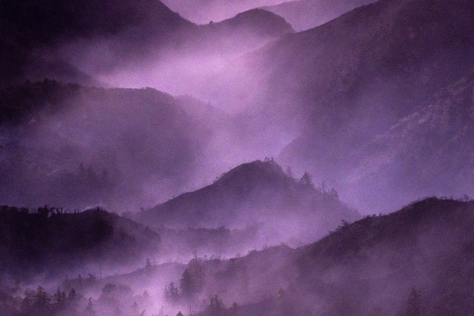 Smoke from the Eaton Fire lingers above the mountains of the Angeles National Forest north of Altadena, Calif., on Jan. 13, 2025.