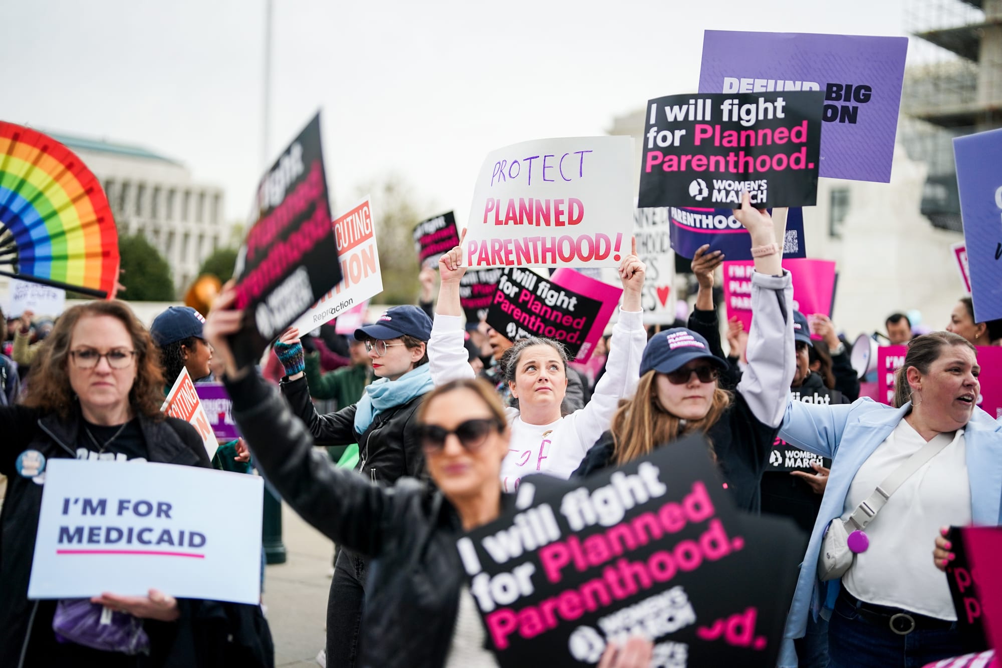 Protestors hold signs in support of Planned Parenthood