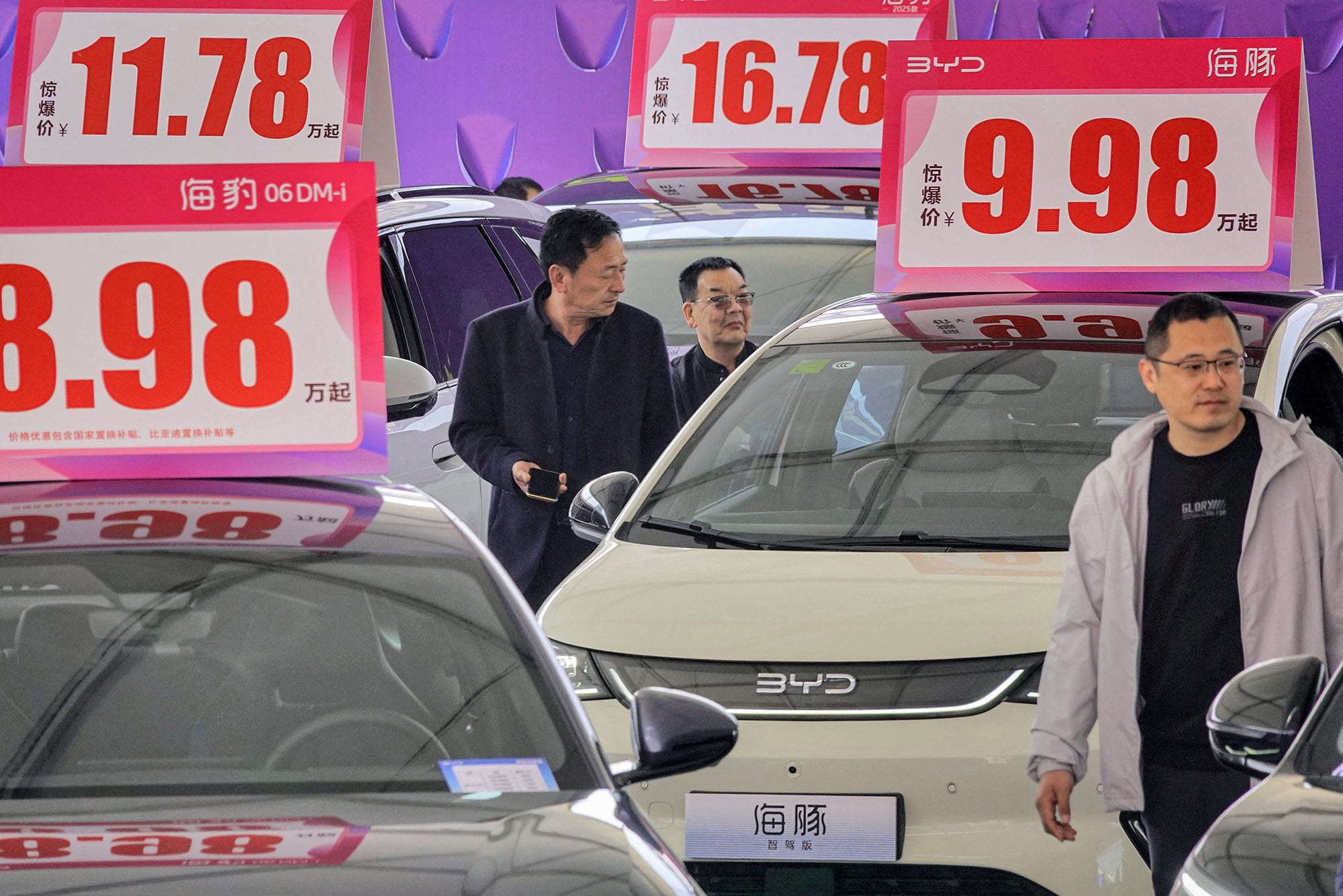 Customers look at BYD electric cars at an auto show in Yantai, China on April 10, 2025.