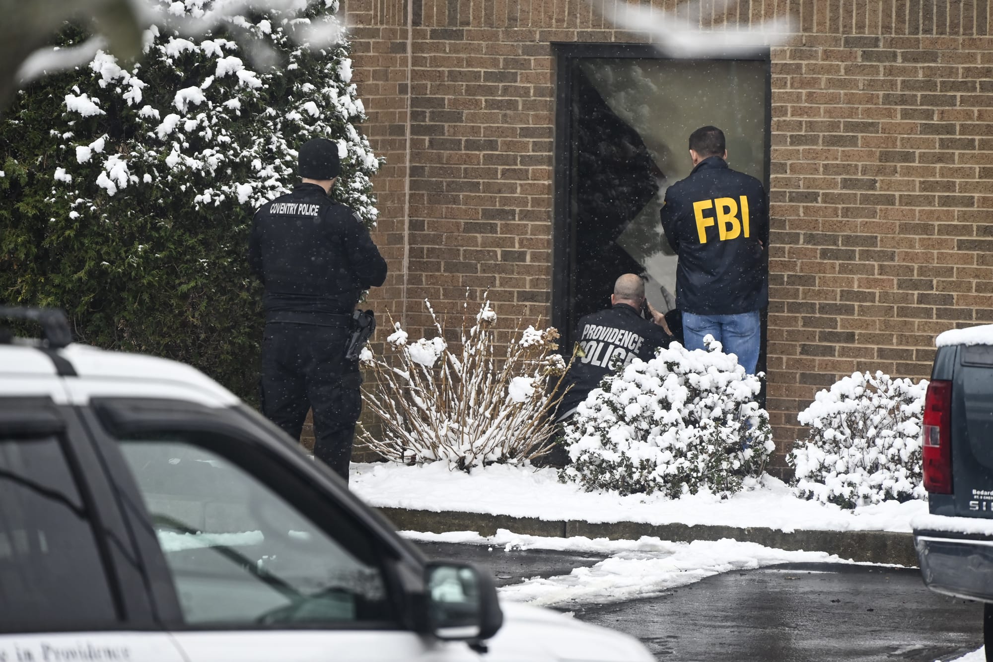 FBI agents canvass the perimeter of the hotel in Coventry Rhode Island