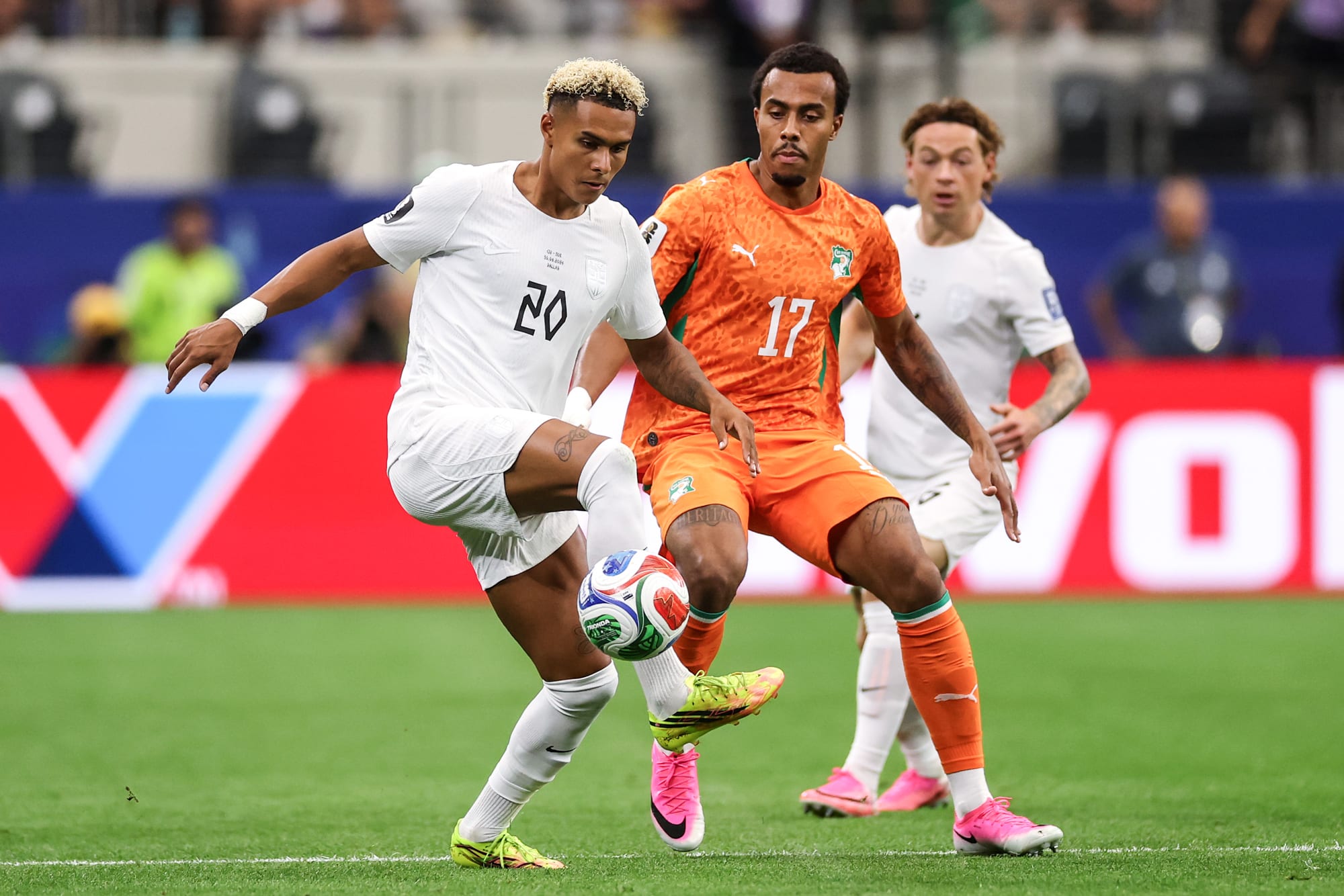 Antonio Nusa of Norway controls the ball under pressure from Guela Doue on the soccer field