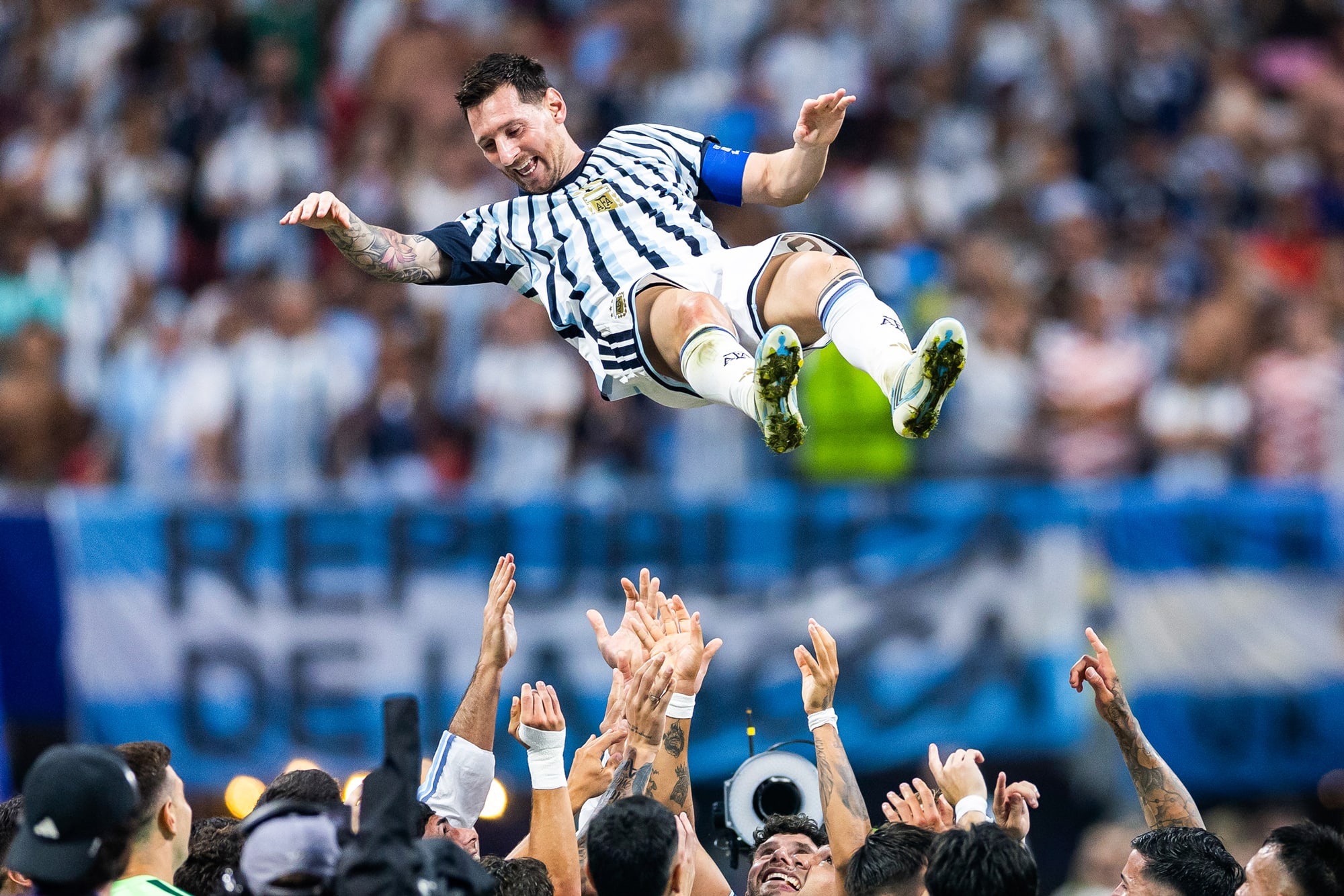 Messi is tossed up into the air by his teammates