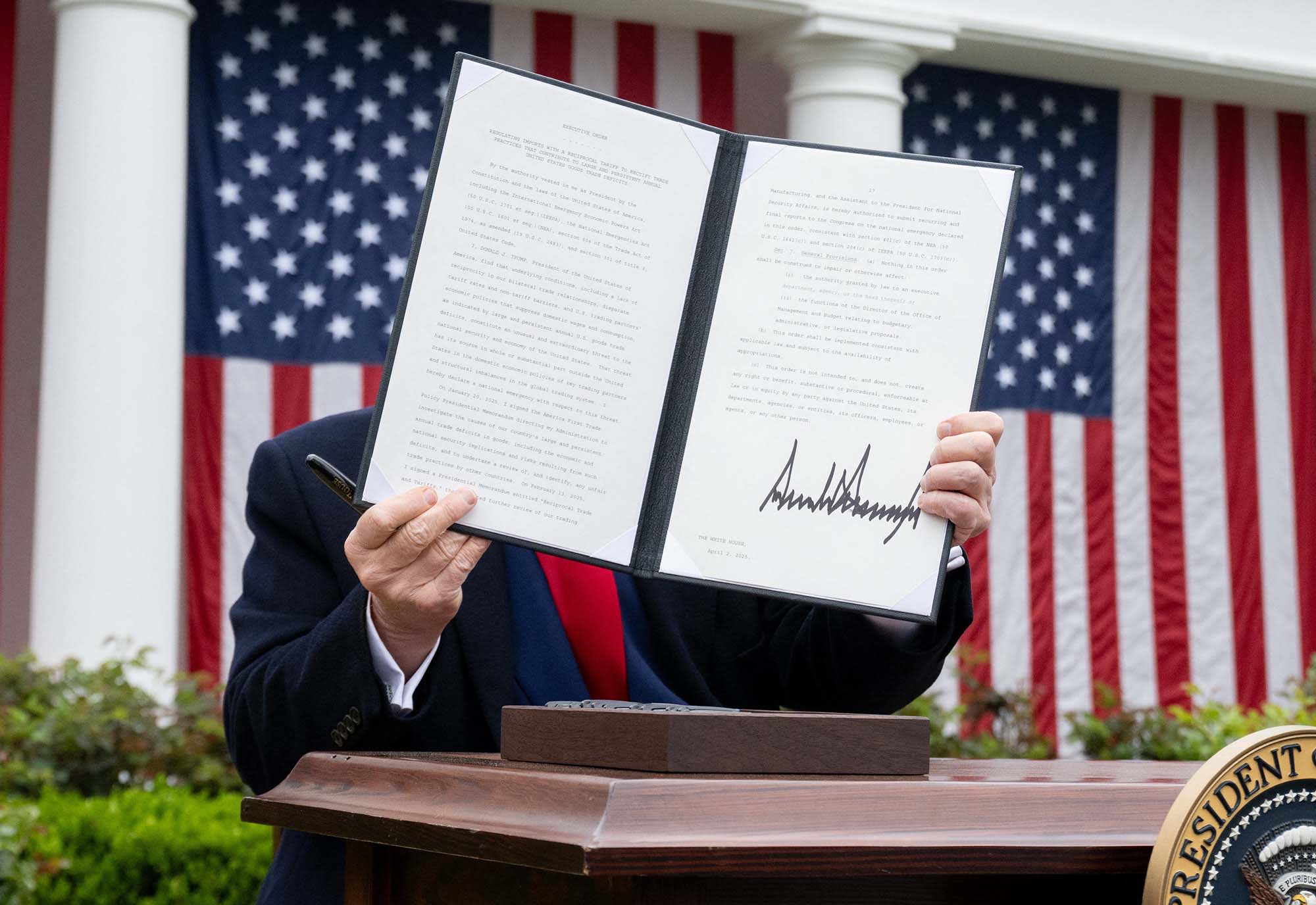 President Donald Trump holds a signed executive order after delivering remarks on reciprocal tariffs at the White House on April 2, 2025.