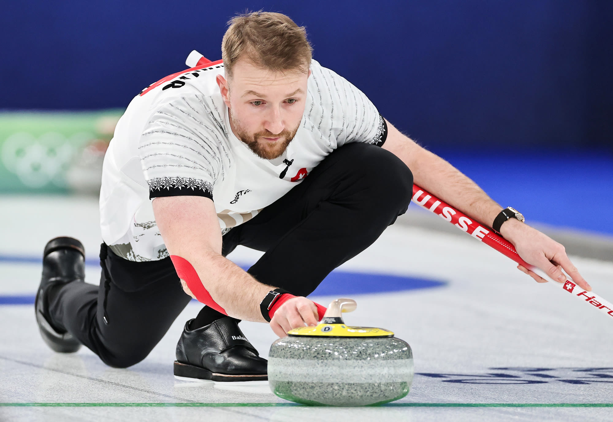 Yannick Schwaller throws a stone on the ice