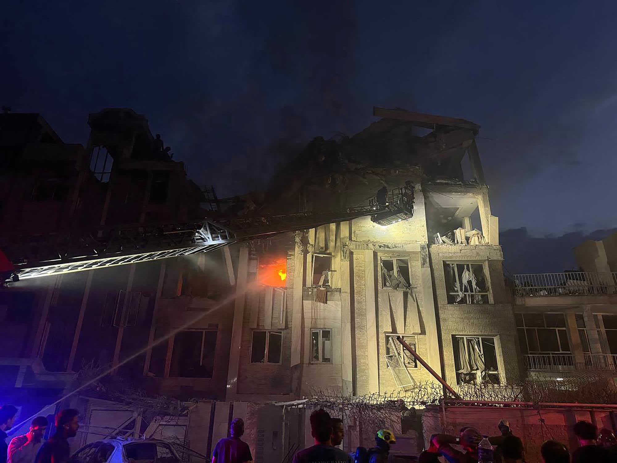 A photo released by Iran's official Sepah News Telegram channel on June 13, 2025 shows a building in Tehran reportedly hit in an Israeli strike on the Iranian capital early on June 13, 2025.