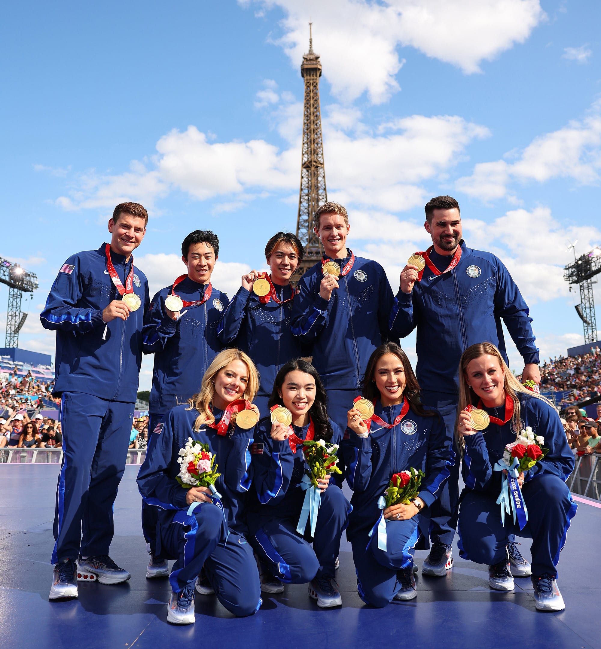 Members of the 2022 U.S. Olympic figure skating team pose in Paris on Aug. 7, 2024, after receiving gold medals following the disqualification of Team Russia for doping.