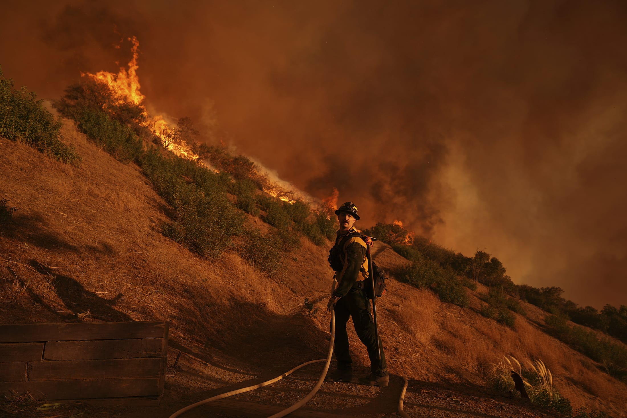 A firefighter battles the Palisades Fire in Mandeville Canyon Saturday, Jan. 11, 2025, in Los Angeles.