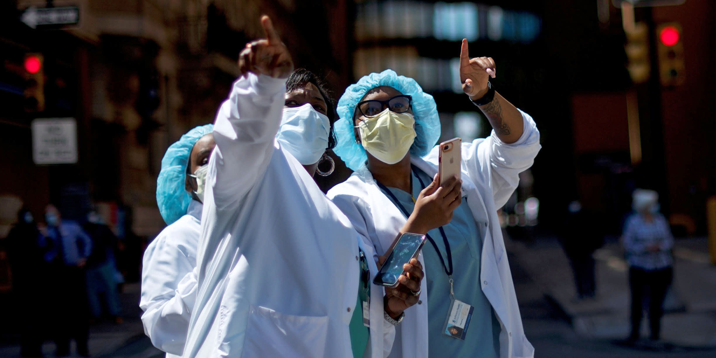 Image: Healthcare workers react as they watch a flyover in Philadelphia