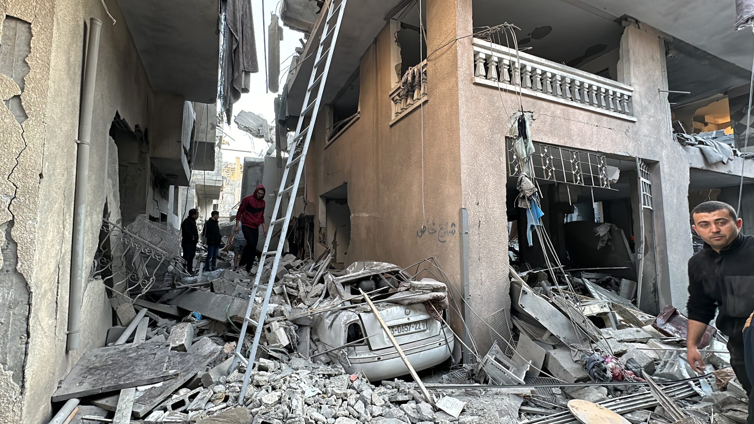 Palestinians survey the damage in Jabalia Camp in Gaza on Dec. 17, 2023.