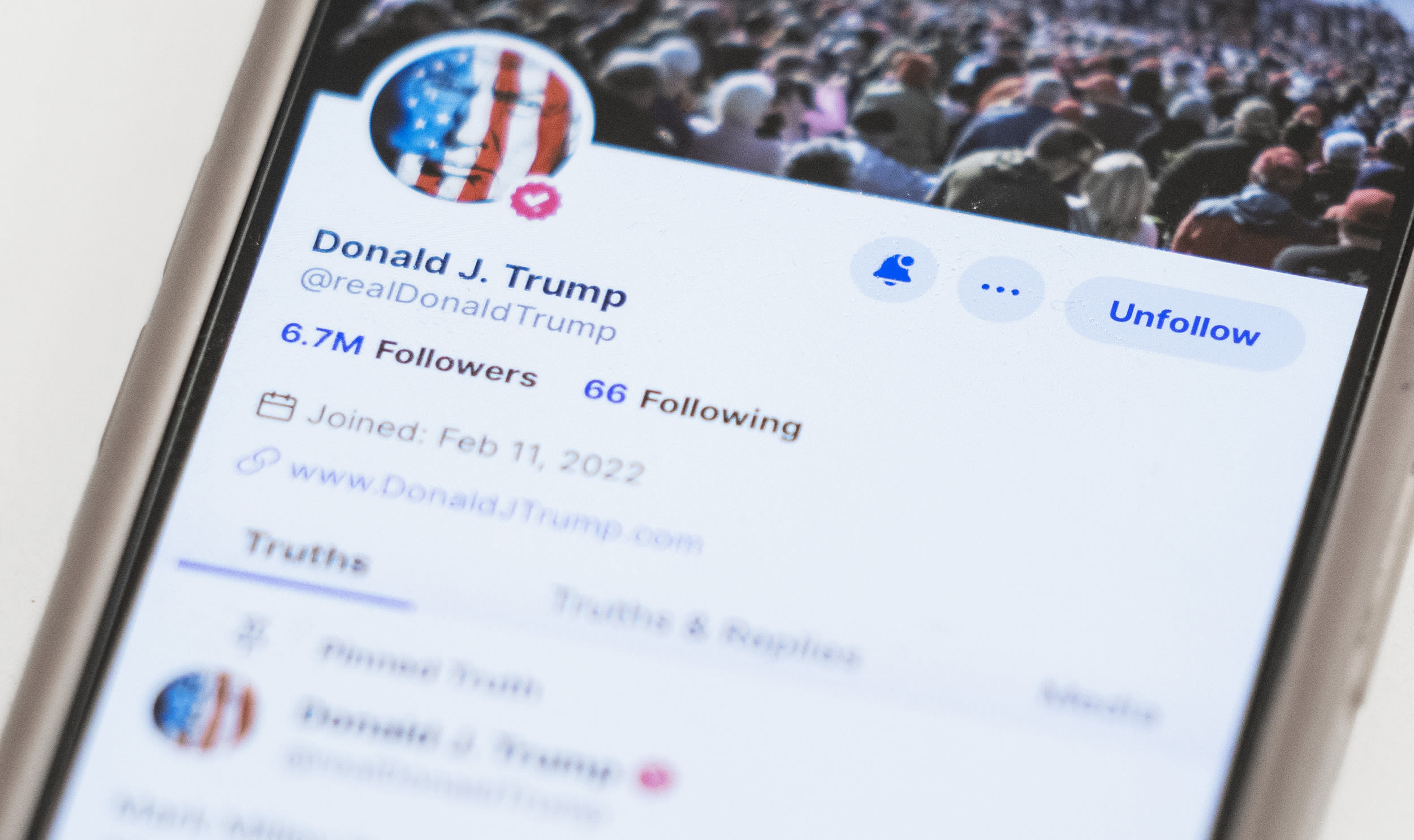 The Truth Social account for Donald Trump is seen on a mobile device.
