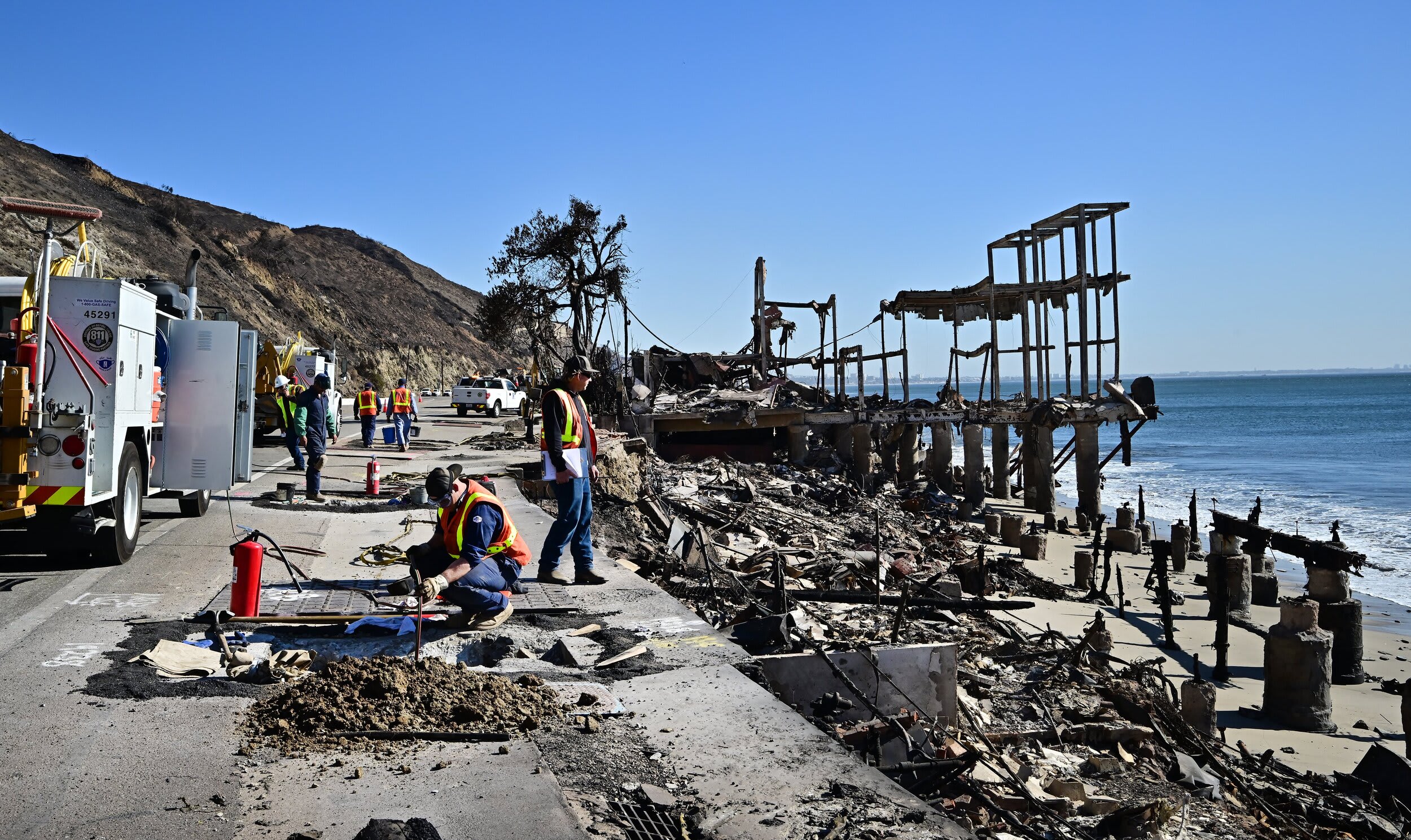 Image: Gas company employees work near the charred remains of beachfront properties destroyed in the Palisades Fire in Malibu, Calif.