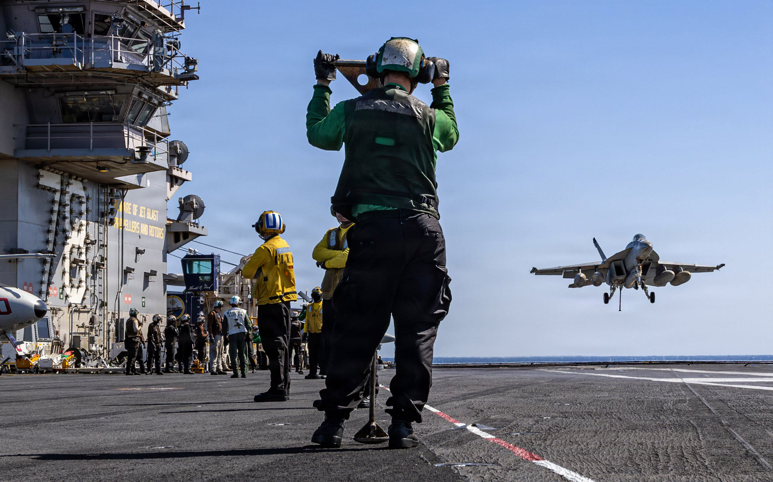 An F/A-18E Super Hornet fighter jet approaches the flight deck of the USS Gerald R. Ford on March 8, 2026, during "Operation Epic Fury.