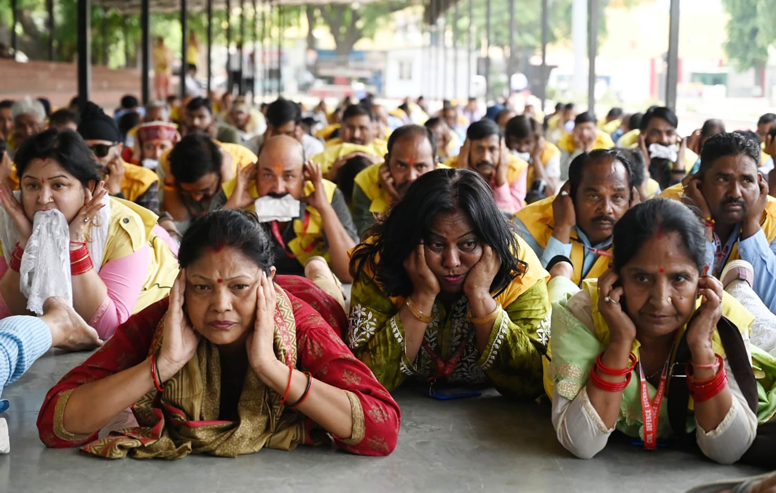 Group of civilians lie down during security drill in Lucknow, India. 