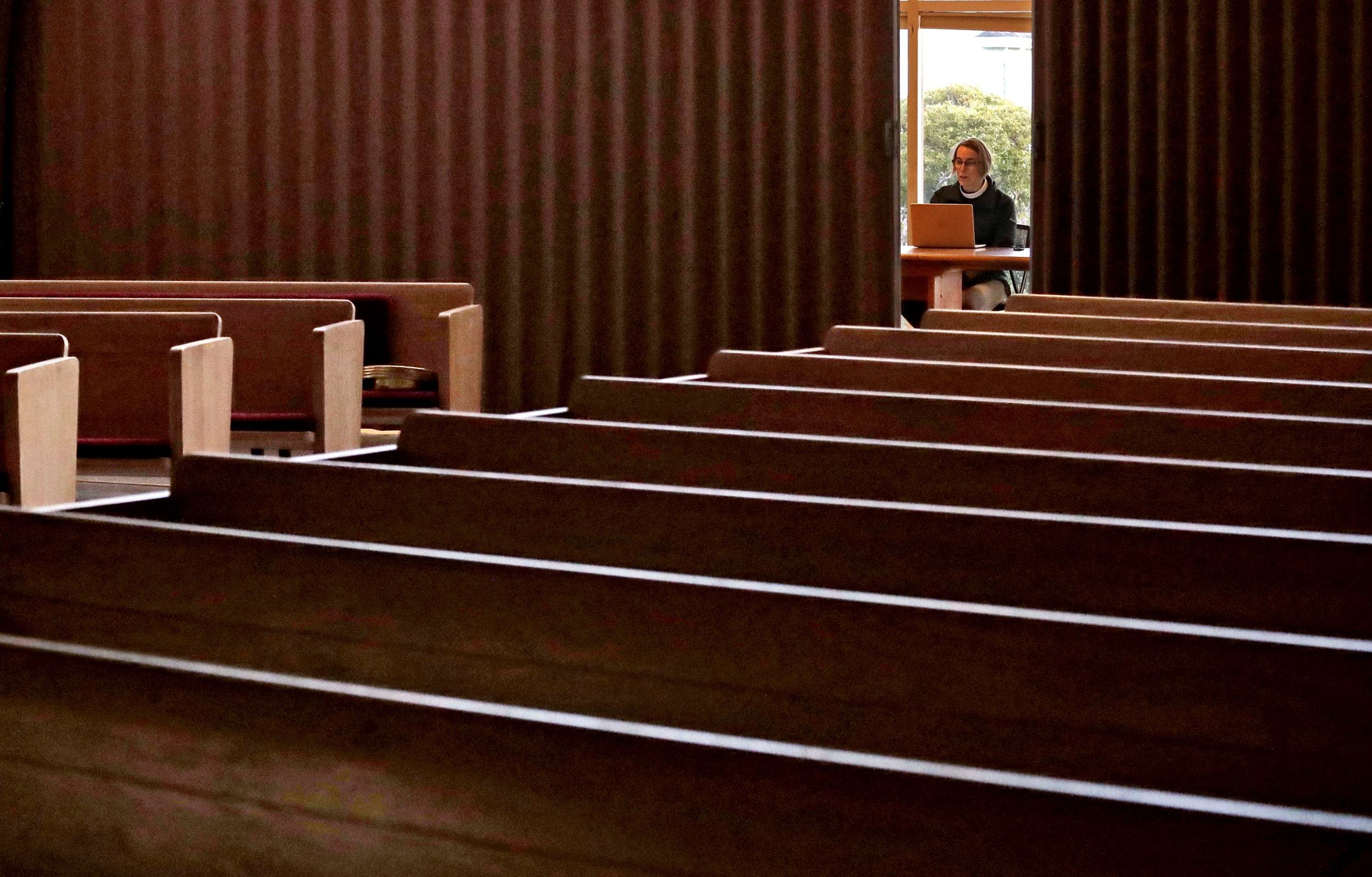 Image: Rev. Kelly Wadsworth live streams Easter service at he Alki United Church of Christ in Seattle on April 12, 2020.