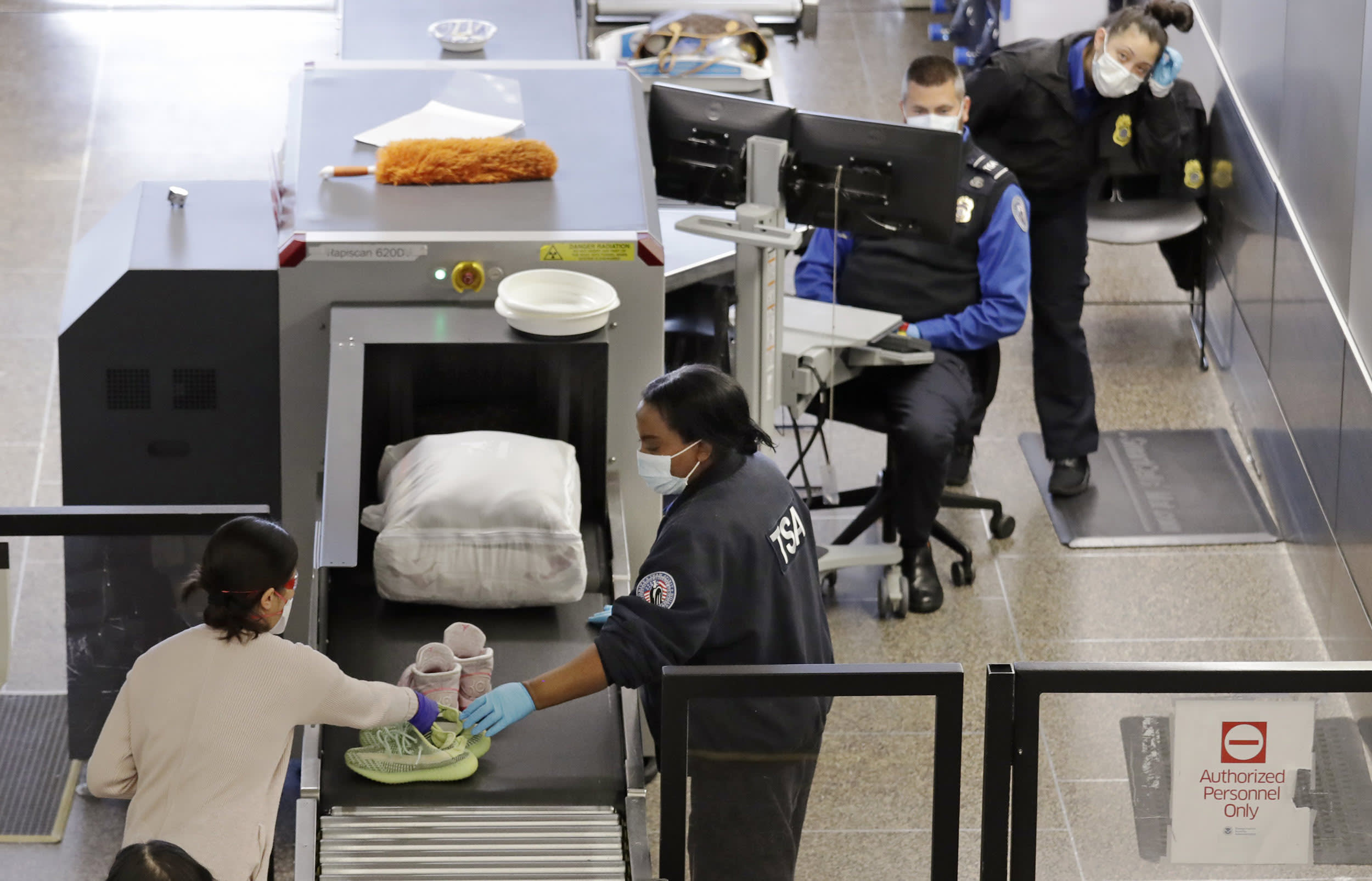 TSA agents screen passengers at Seattle-Tacoma International Airport on April 15, 2020.